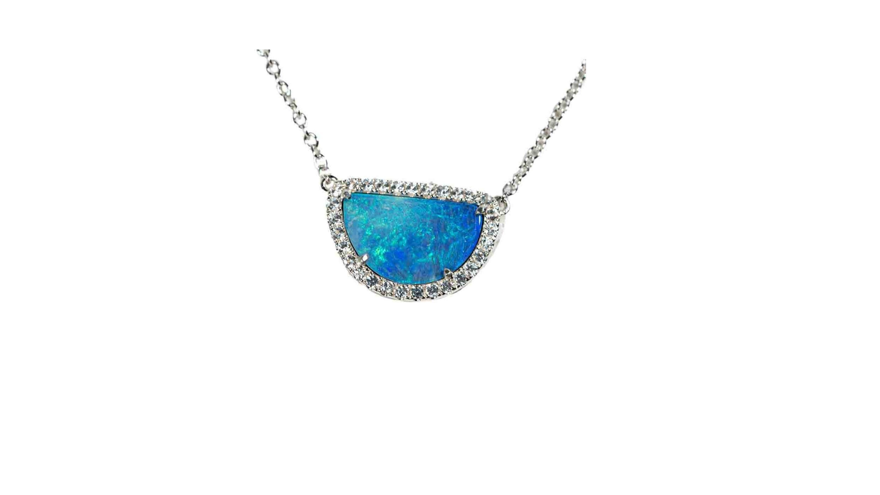 Australian Opal Necklace stands out with the White topaz stones  is like a sparkling half moon on a cold winters night...magical and hypnotizing in every way possible. Hand carved to give the stone a glowing finish. Featuring gem quality