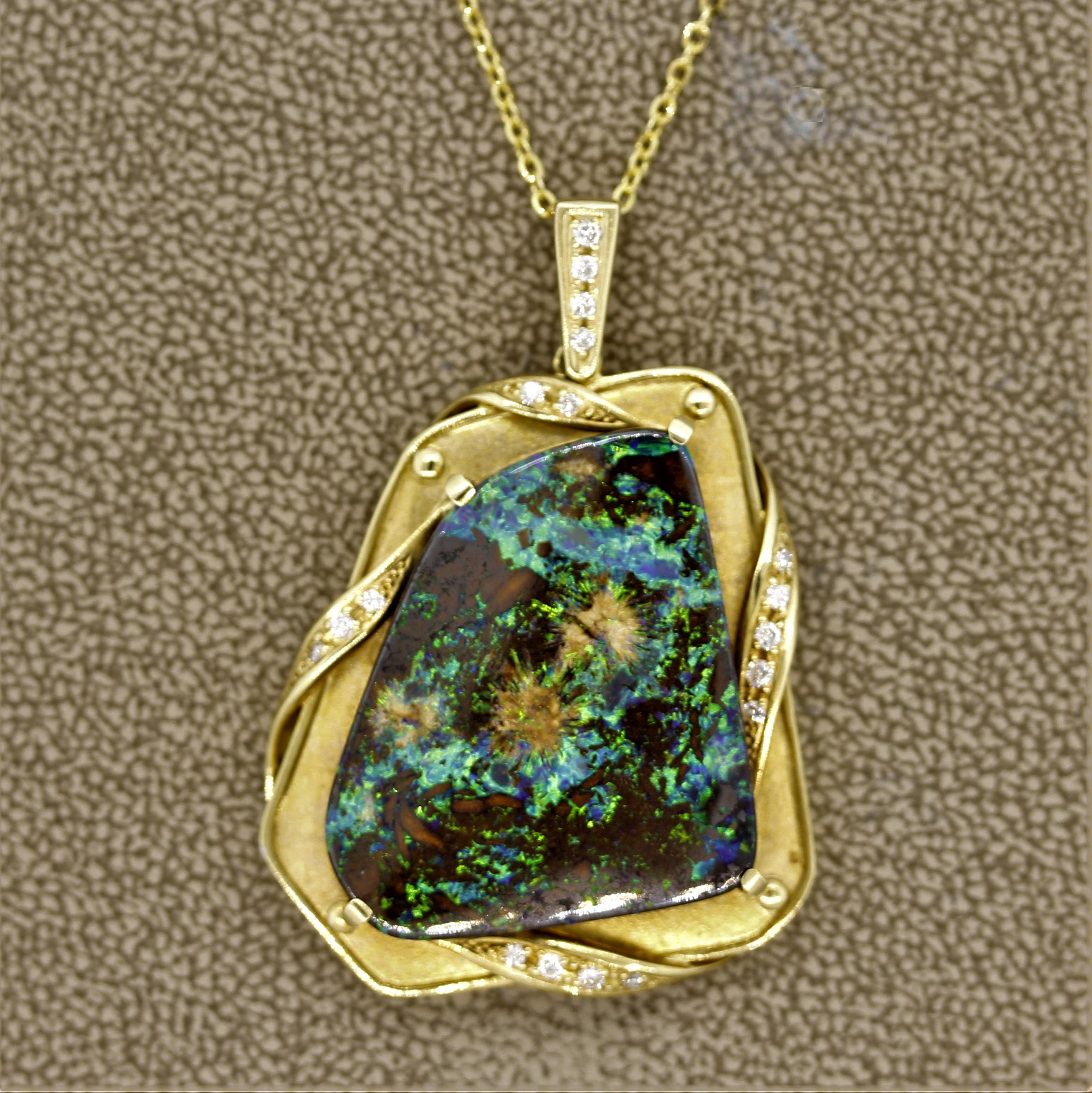 A luxurious pendant featuring a large Australian boulder opal weighing 27.92 carats. It has great play of color with strong flashes of green and blue across the opal. The pendant is accented by 0.22 carats of round brilliant cut diamonds set in a