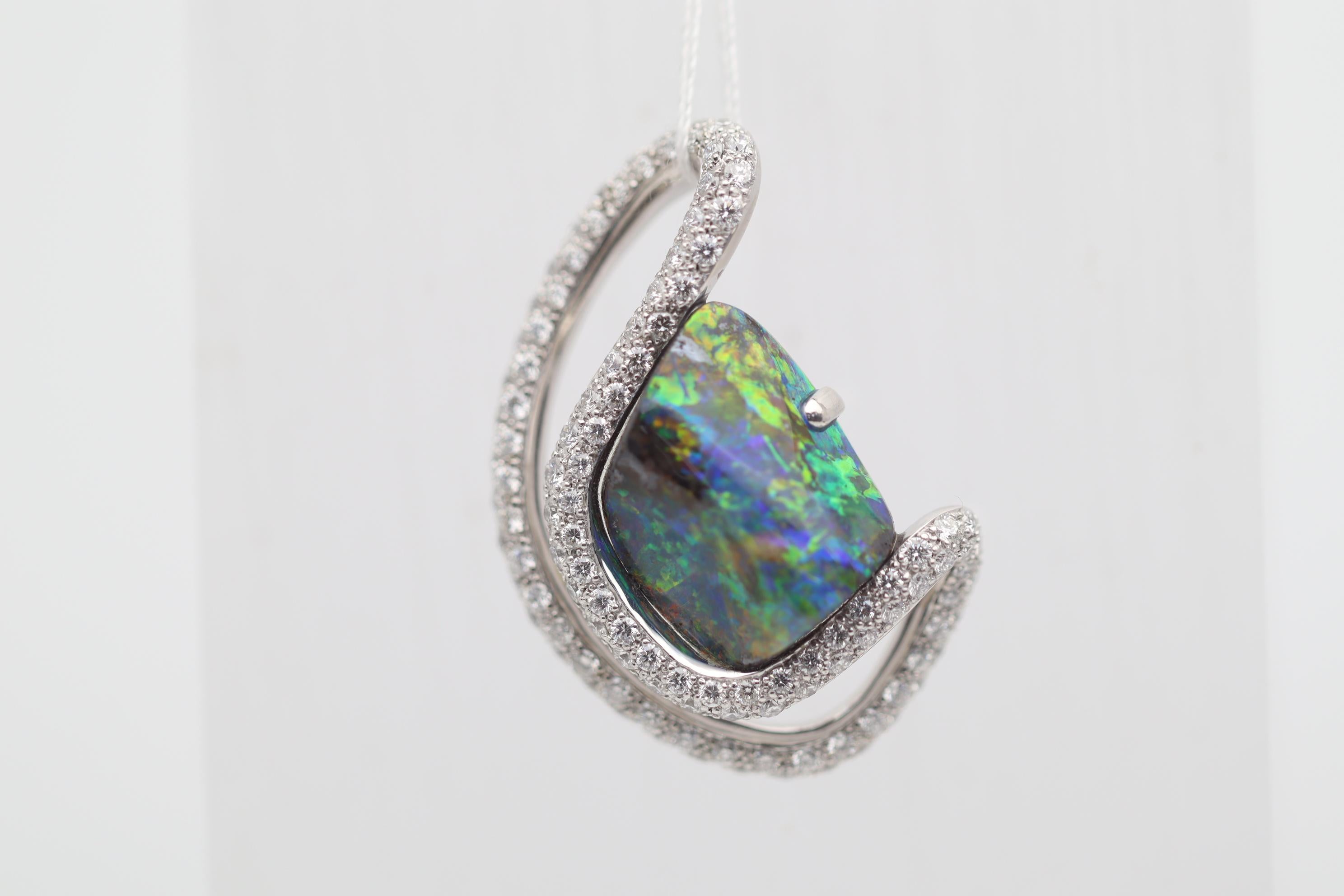 Une superbe démonstration de couleurs. Cette fantastique opale fine d'Australie pèse un poids impressionnant de 15,42 carats et présente d'étonnants jeux de couleurs, des éclats lumineux de verts, bleus, oranges, jaunes et rouges dansant à travers