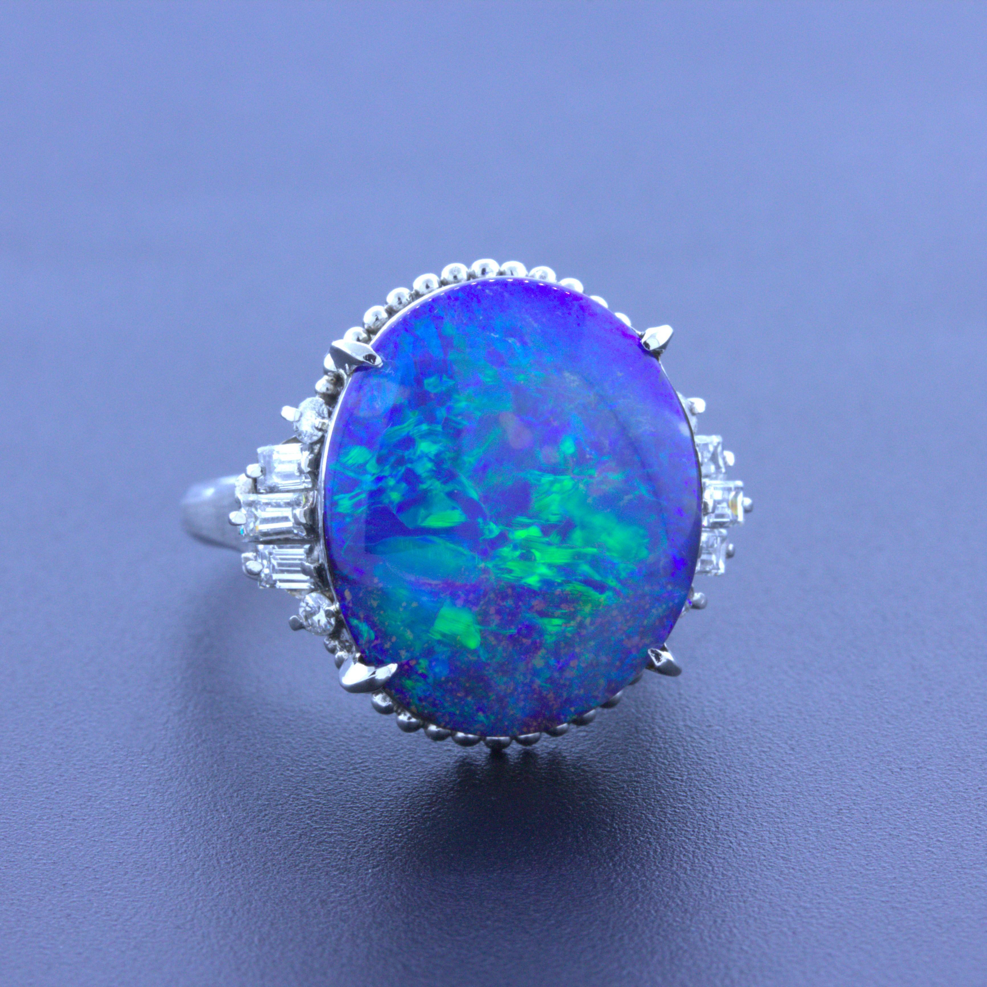 A simple yet classy platinum ring featuring a 9.47 carat Australian boulder opal. The opal has great play-of-color as flashes of blue, green and turquoise can be seen across the stone. The ring is complemented by 0.50 carats of baguette and round