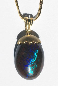 Australian Boulder Opal Pendant Hanging from a 23kt Gold Necklace