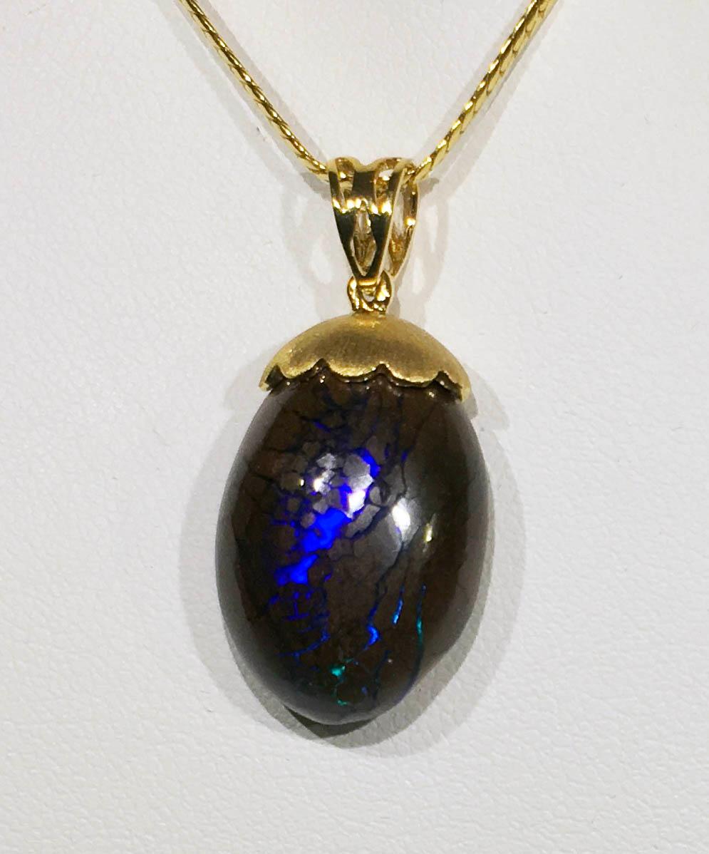 Australian Boulder Opal Pendant Hanging from a 23kt Gold Necklace 1