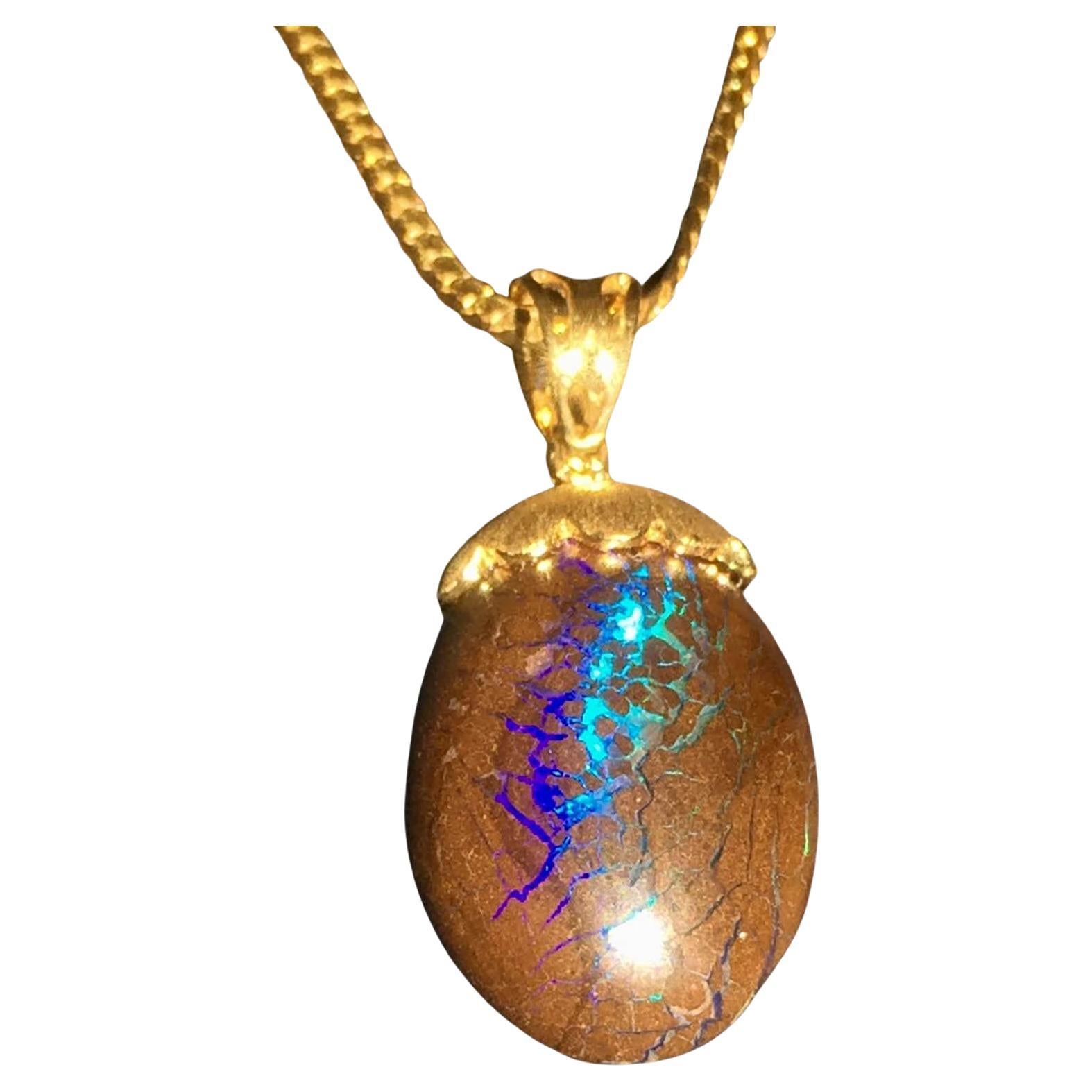 Australian Boulder Opal Pendant Hanging from a 23kt Gold Necklace