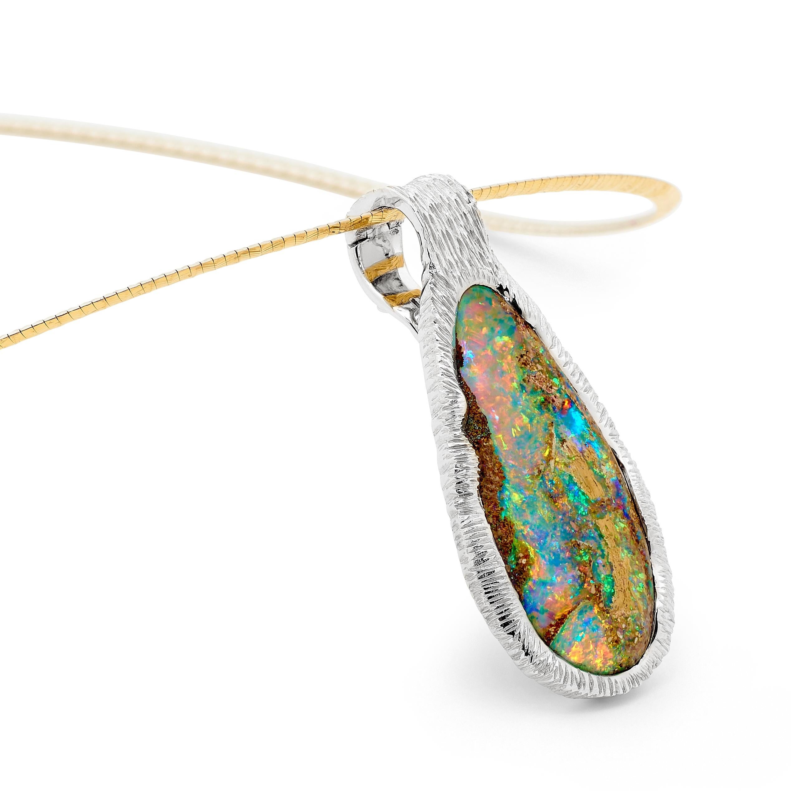 “Life Plentiful” presents a splendid 21.60 carat boulder opal from our Jundah-Opalville mines wrapped in 18K white gold. The beauty of this piece lies in the element of surprise; just when you think you know it well it reveals yet another bright and