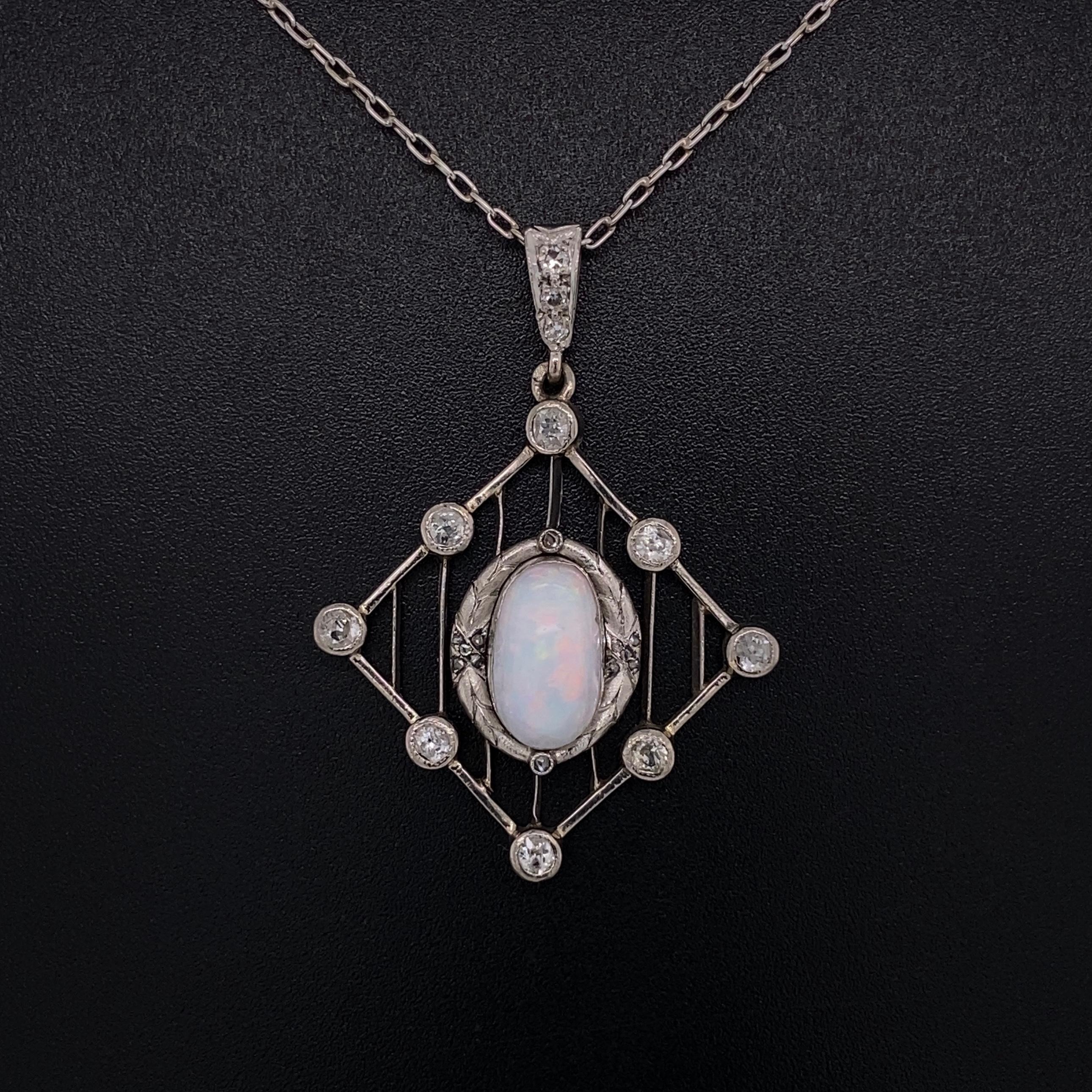 Simply Beautiful! Australian Crystal Opal and Diamond Platinum Art Deco Pendant Necklace. Center securely Hand set with an Australian Crystal Opal surrounded by 11 round old Mine-cut Diamonds, approx. 0.80tcw. Beautiful design Hand crafted in