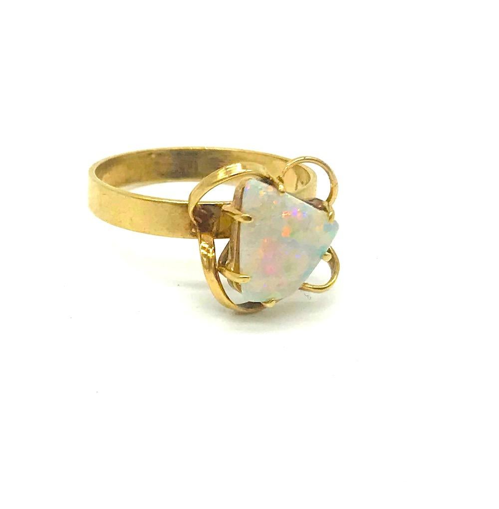 Beautiful and colorful Austrian Fire Opal most desirable quality.
 A flair of an Organic Artesian, style is in custom made ring which features a  5 Carat center stone.
 Ring is embossed 5 carat.
Engraved January 2007

The width is. 3 mm wide band of