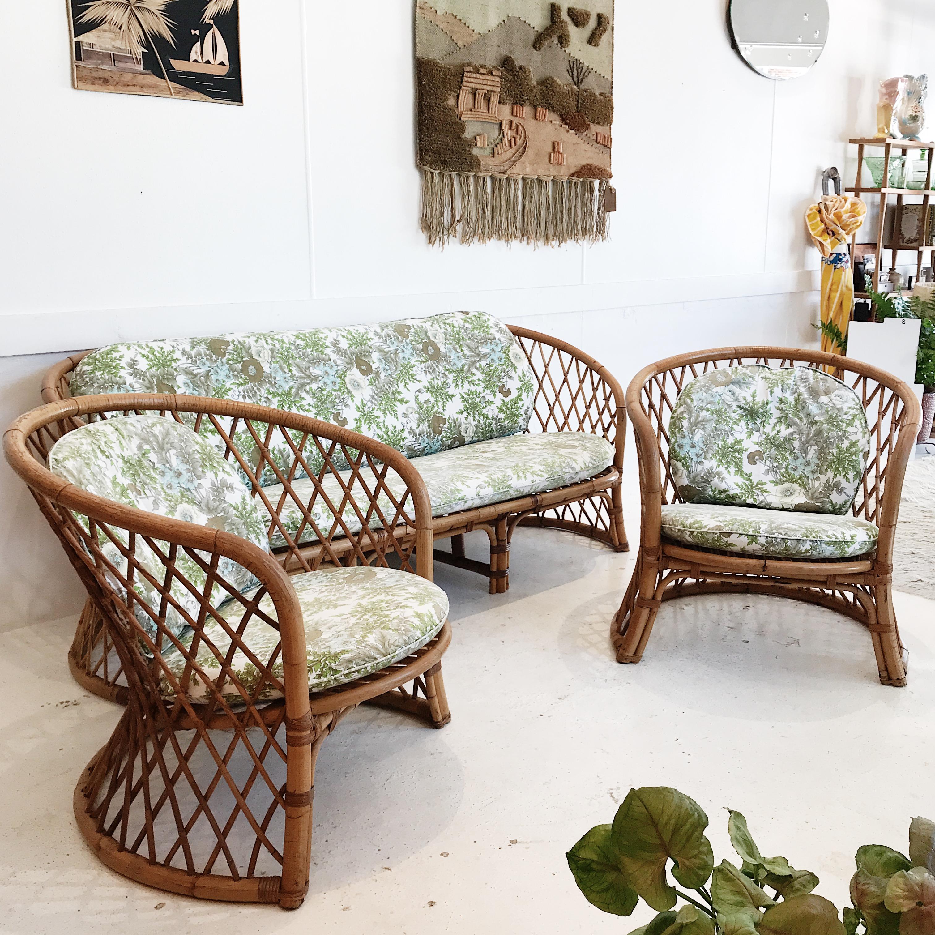 Australian midcentury three-piece rattan lounge suite with lovely, original cotton cushion covers. Fabric features liberty style, native floral pattern, in tea, olive green, and baby blue.

This set is in marvellous visual and structural