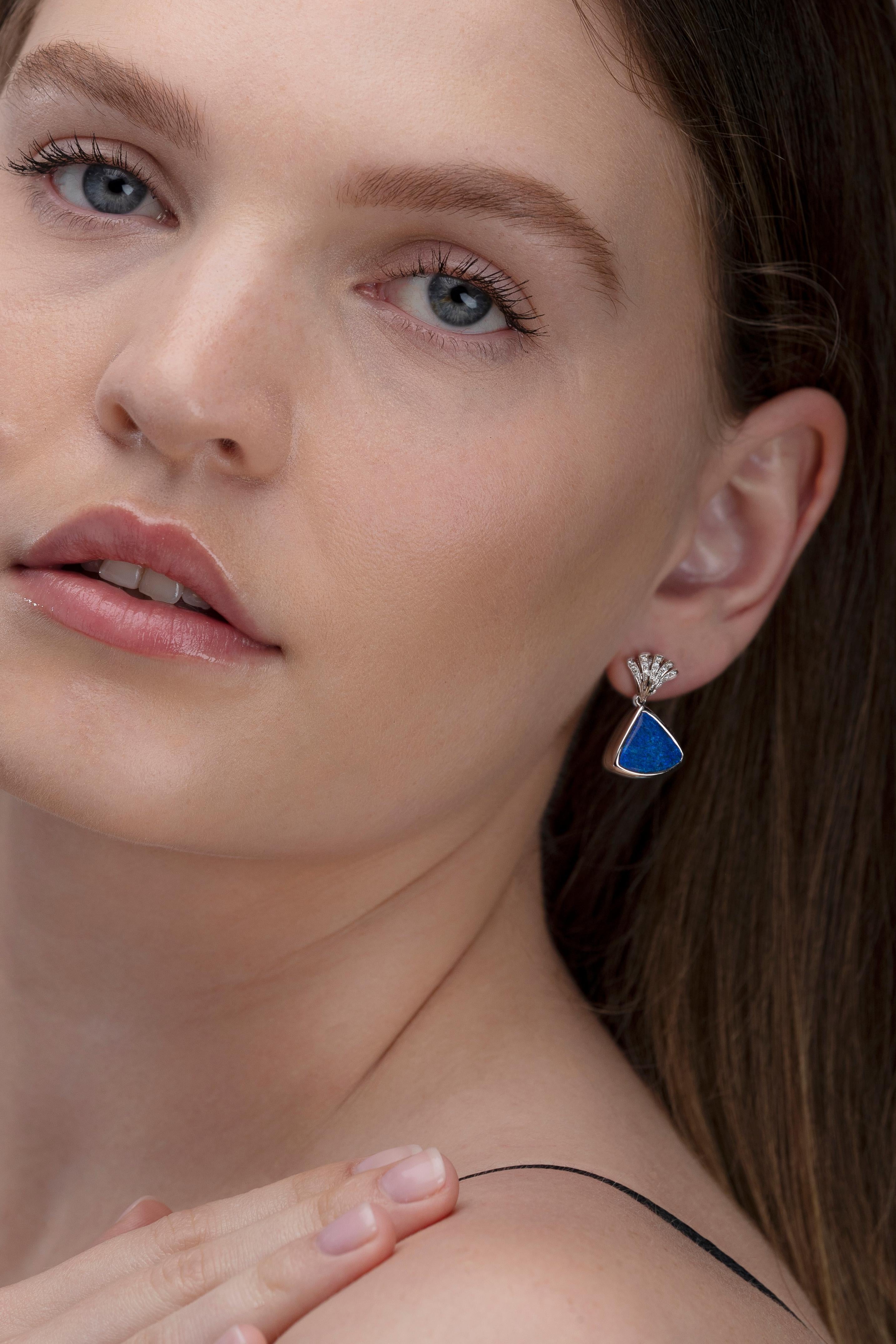 The first blossoms of spring inspired the creation of “Snowdrops” opal earrings. This perfect pairing of black crystal opals (12.84ct) is complemented by the brilliant flash of 30 diamonds. The opal’s cool play-of-colour is further intensified by