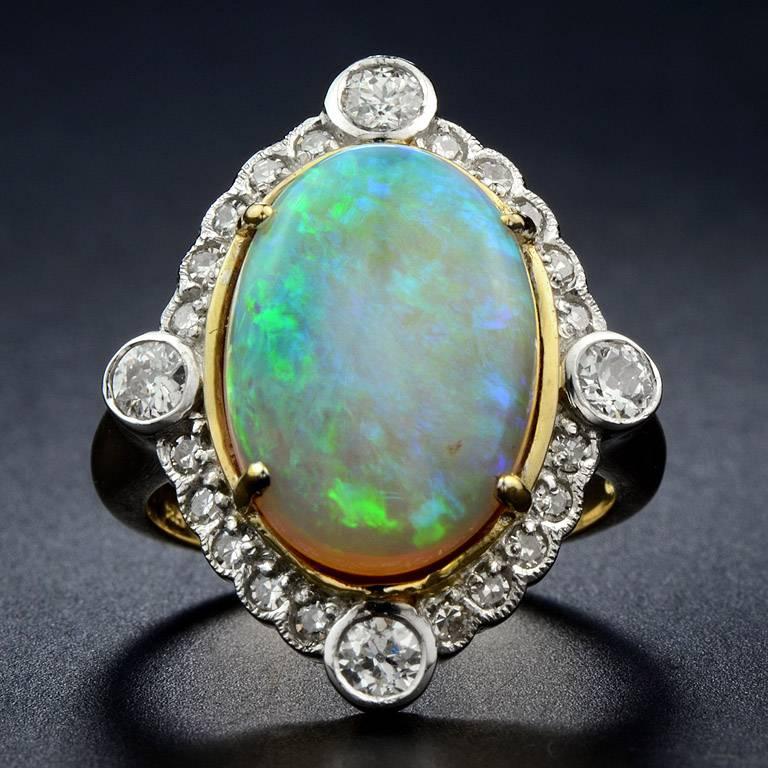 Opal From Australia 5.70 Carat Set with Diamond Total 24 Pieces.  4 Diamond at the Corner Weight 0.45 Carat surrounding by 0.32 Carat Diamond.  This Ring was made in 18K Yellow Gold Size US#7