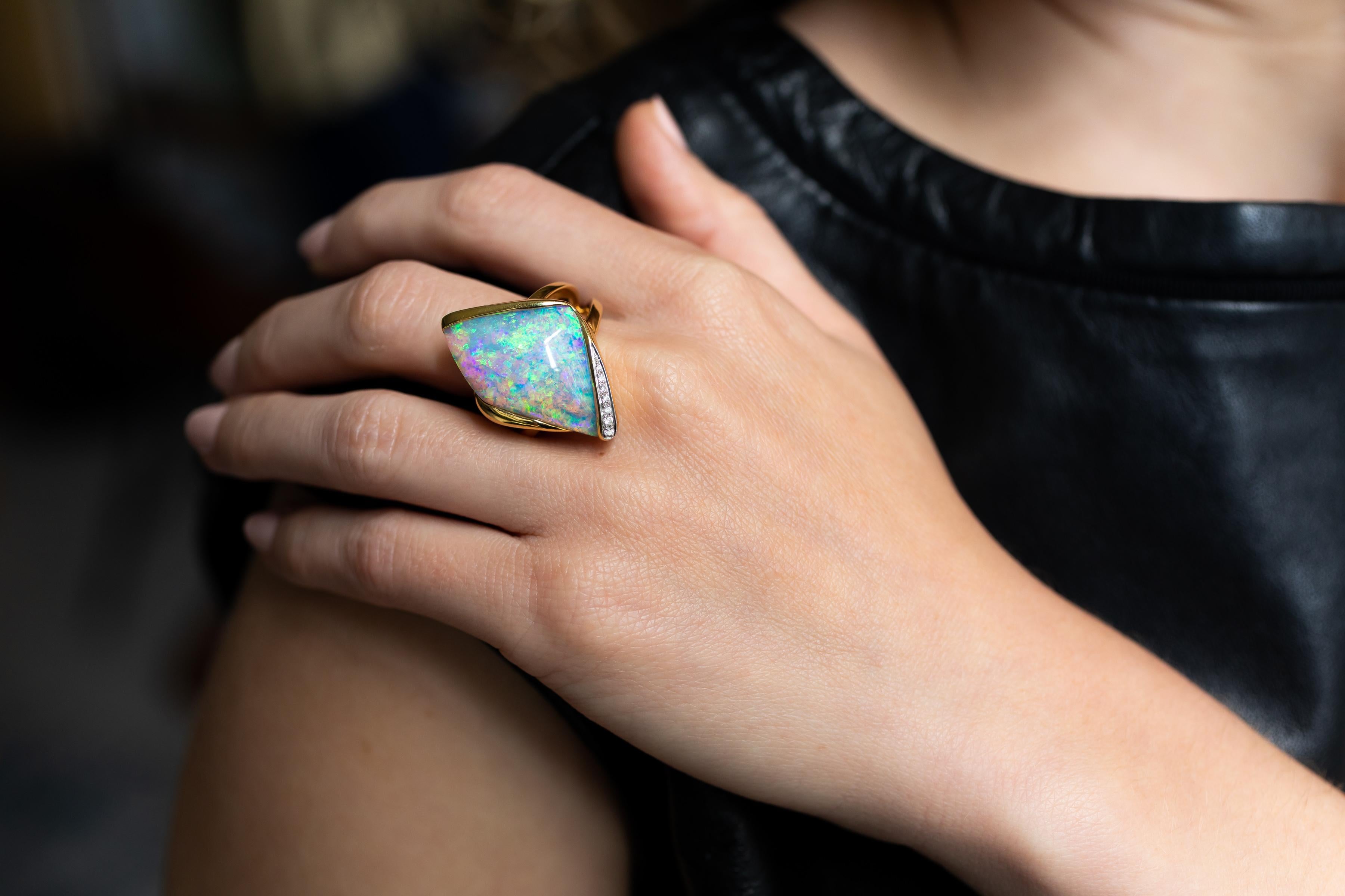 Mysterious and magical, “Deep Love” opal ring is evocative of an ocean dive on a lazy summer day. A superb 17.53 carat pipe opal from our own mines in Jundah-Opalville is the star of this bold and impressive cocktail ring. The unusual 18K yellow