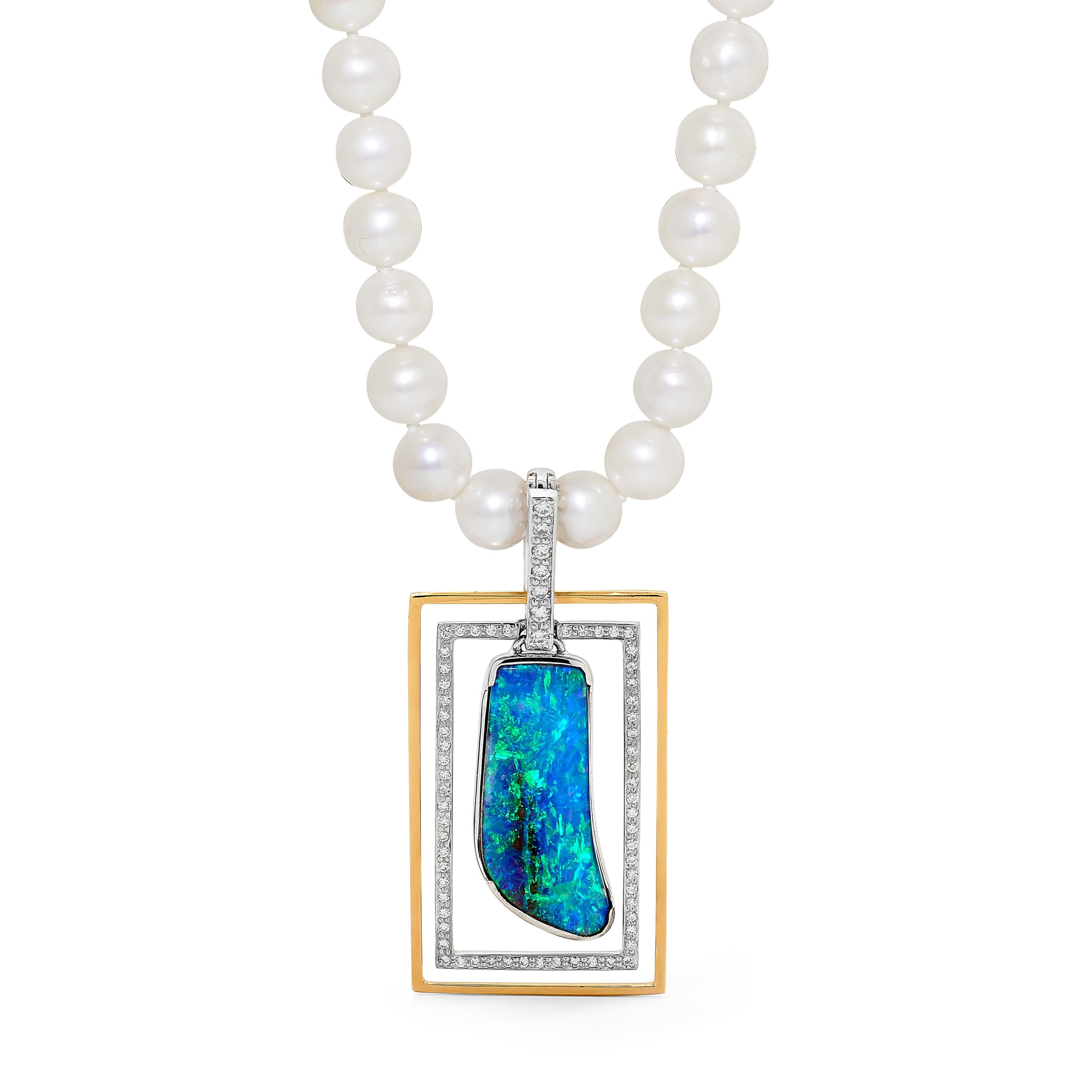 “E=mc2” opal pendant was inspired by the shifting paradigms of modern physics. The beauty of this exquisite freeform Winton boulder opal (14.97ct) is heightened by icy diamonds and its geometric 18K white and rose gold setting. The frames separate