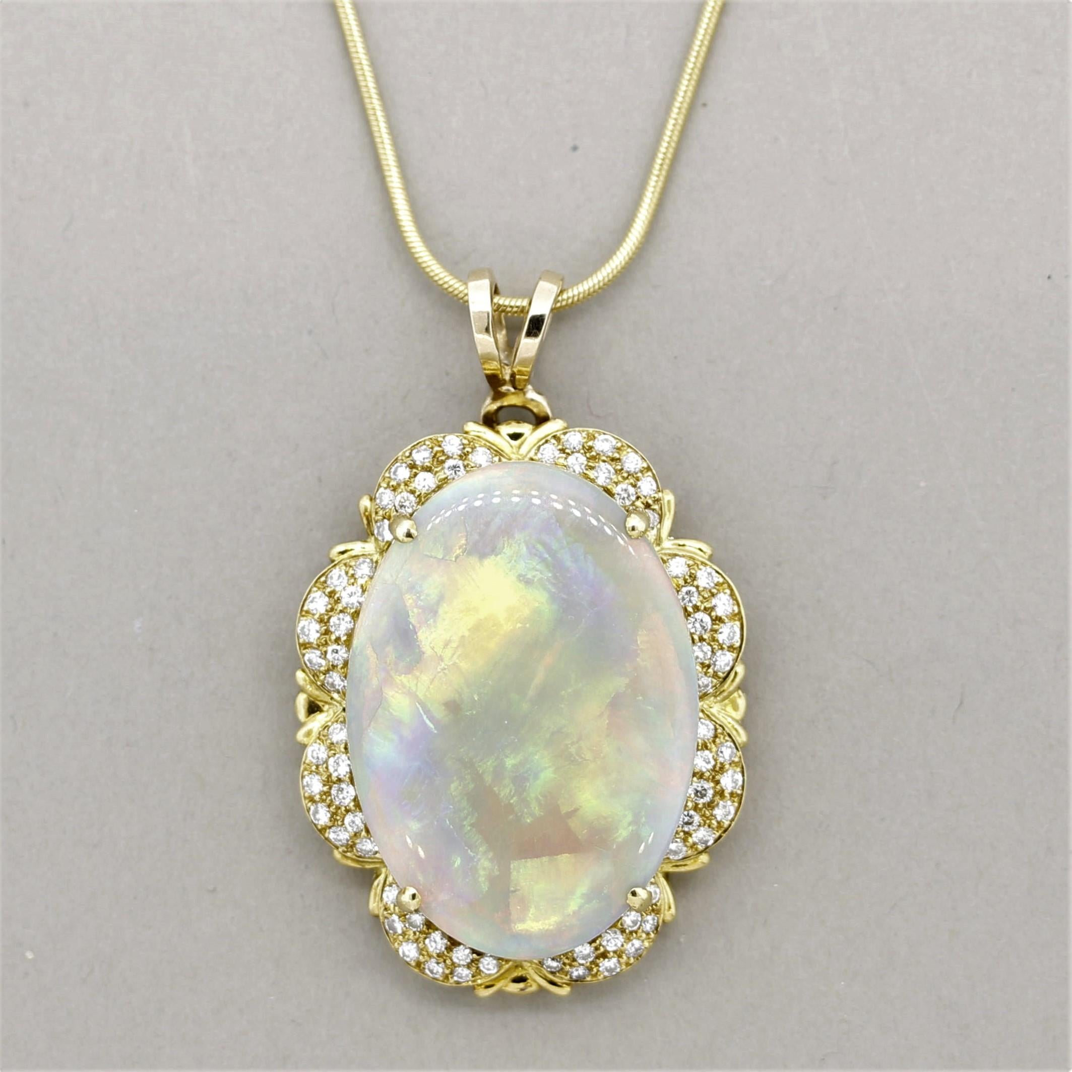 A large and impressive Australian opal takes center stage! It weighs approximately 12 carats and has excellent play-of-color. Bright and large flashes of predominantly red, green, and orange can be seen across the entirety of the opal as well as