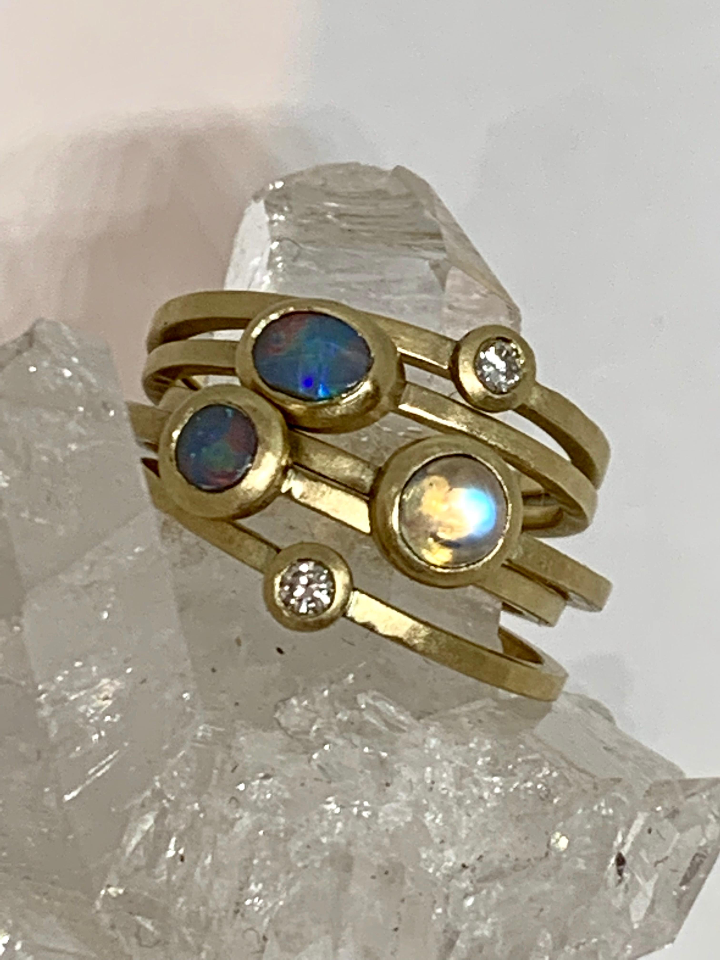 Andrea Estelle Jewellery handmade opal stack rings featuring 2 solid Australian Black opals from Lightening Ridge in Australia. With beautiful blues, greens and reds these are complimented beautifully with 2 diamonds and a rainbow moonstone to form