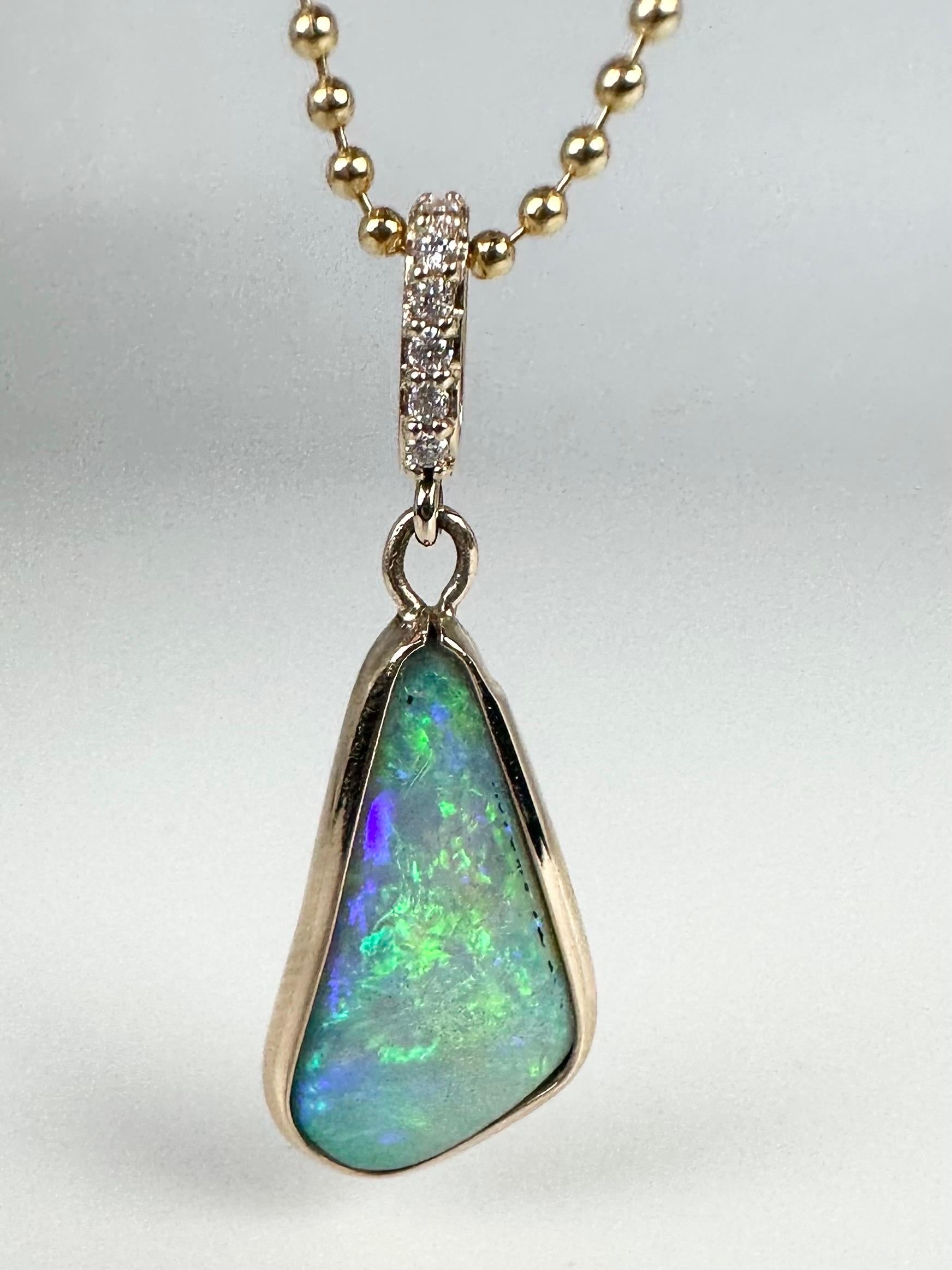 Unique Modern Australian opal pendant with diamonds on the top in 14KT yellow gold. Comes with a fancy chain!

GOLD: 14KT gold
NATURAL DIAMOND(S)
Clarity/Color: VS/F-G
Carat:0.06ct
Cut:Round Brilliant
NATURAL OPAL(S)
Color: Rainbow
Grams:3.60
Item#: