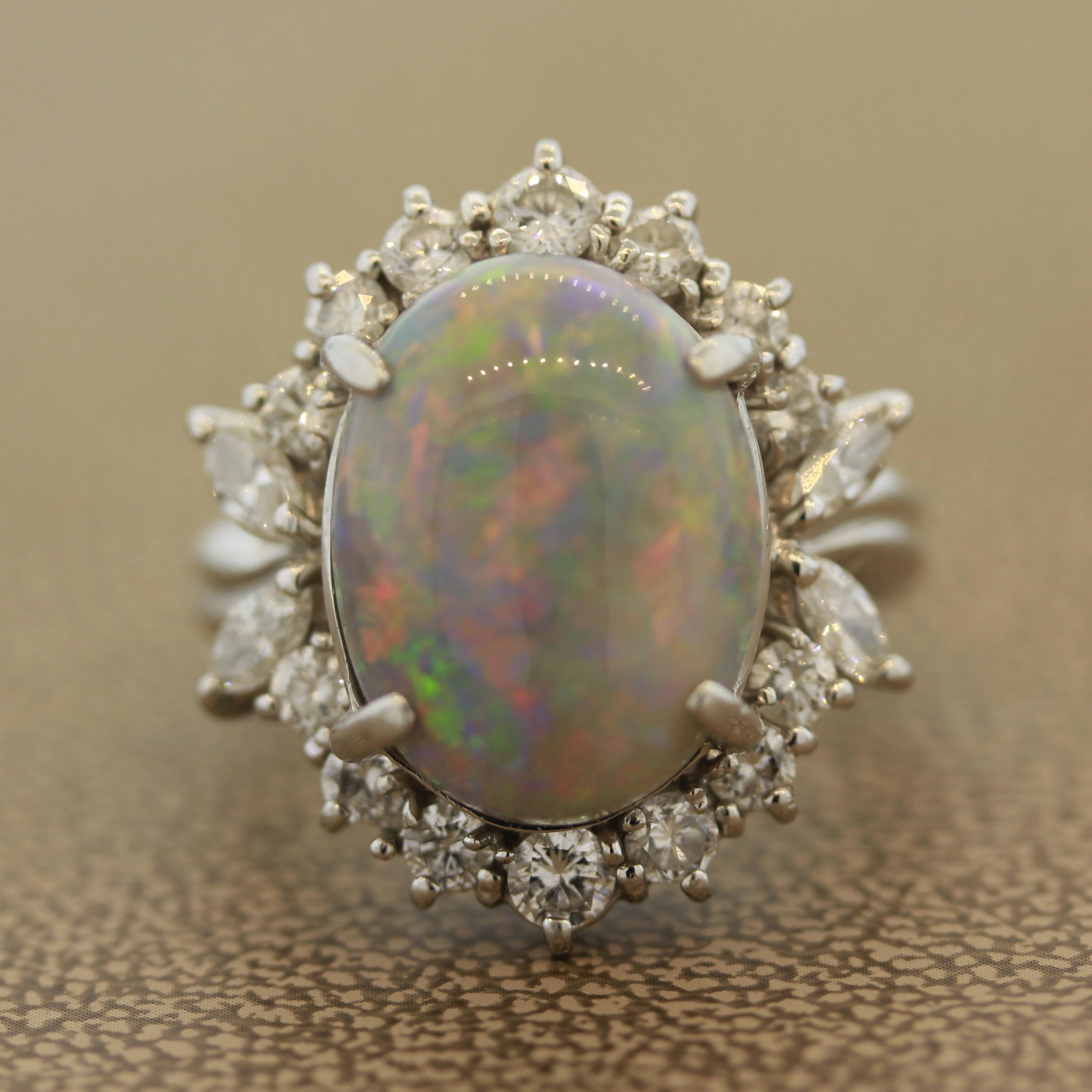 A special Australian opal, most likely from Lightning Ridge, takes center stage. It weighs 8.03 carats and has excellent play of color as the entire piece of opal is covered in flashes predominantly red and orange with greens and purples as well. It