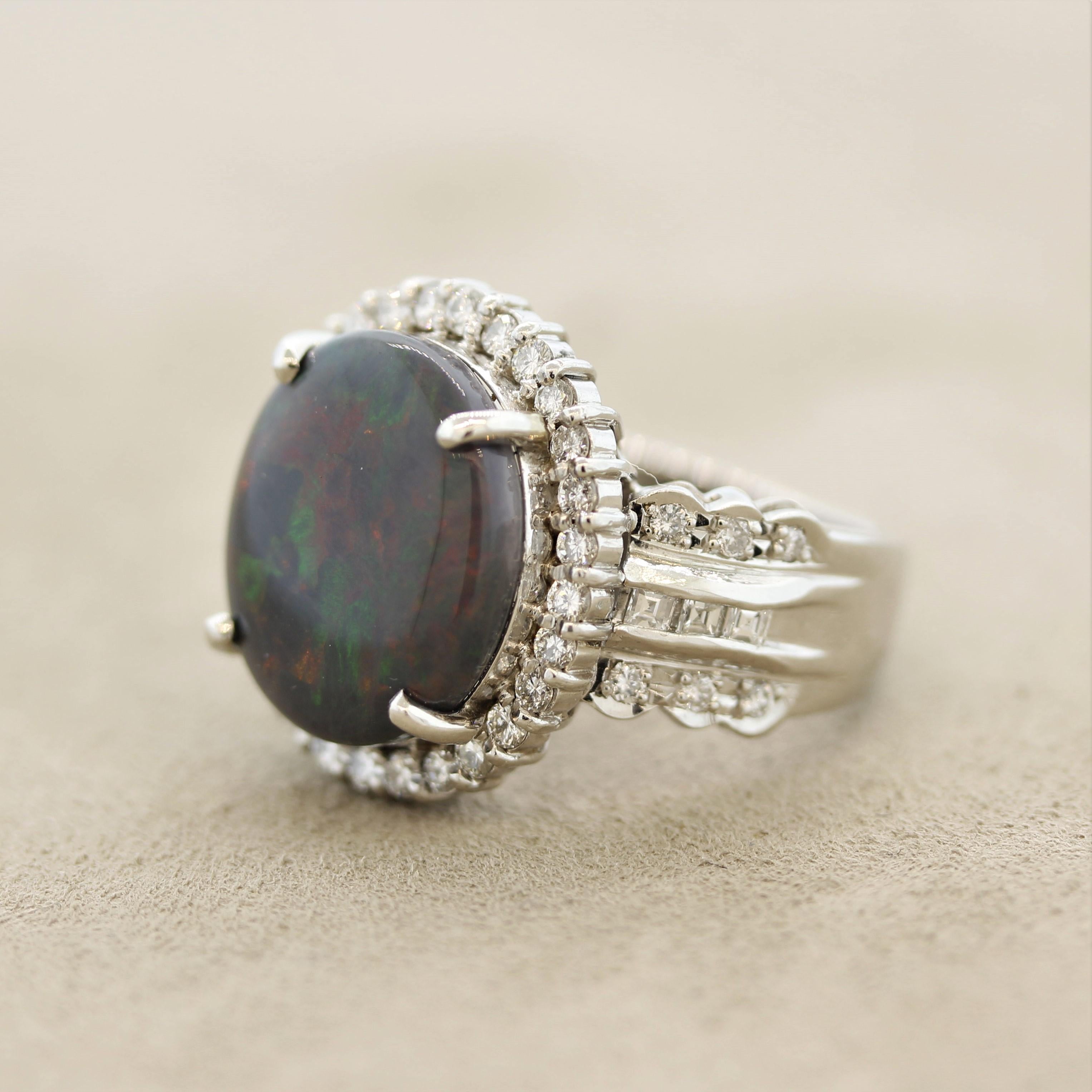 A lovely platinum made ring featuring a 2.95 carat natural Australian opal. It has great play-of-color as bright strong flashes of green, blue and some yellow/orange dance across the stone. It is complemented by 0.61 carats of round and baguette-cut