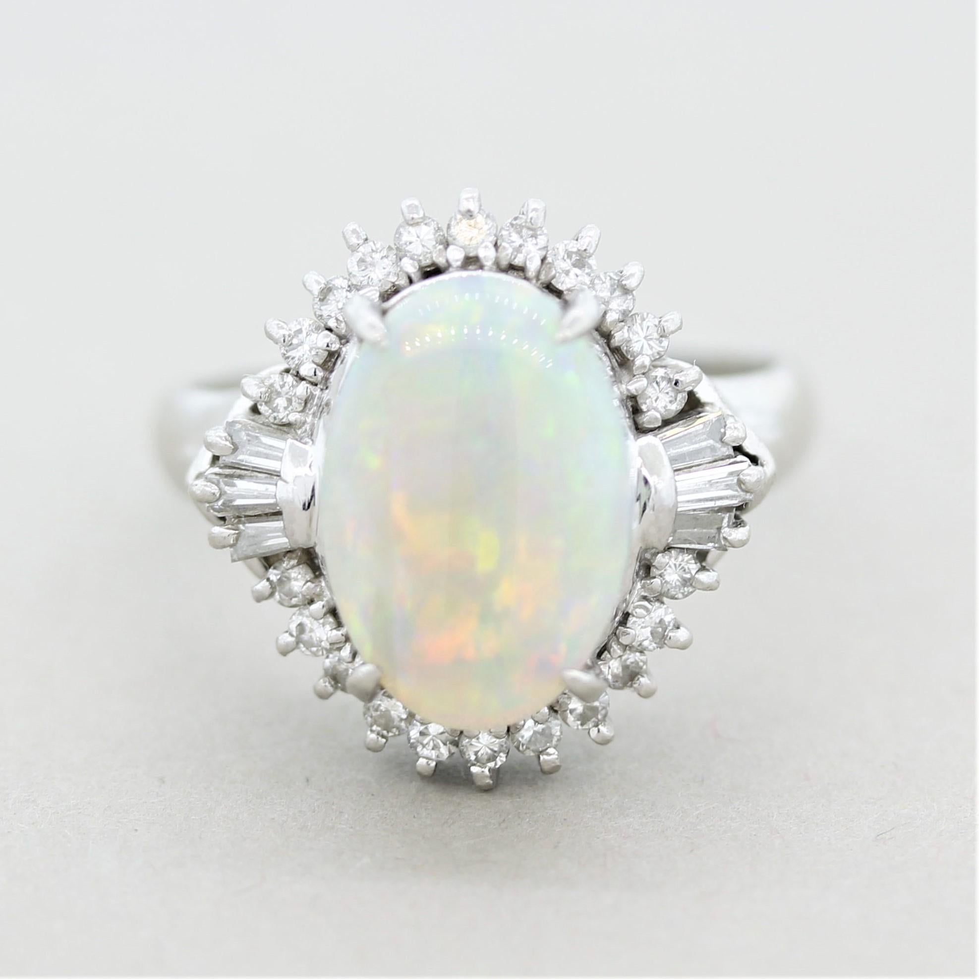 A simply stunning Australian opal takes center stage! It weighs 3.33 carats and has excellent play-of-color as large and bright flashes of color can be seen across the entire opal. The primary colors are red, orange, and green with hints of blues,