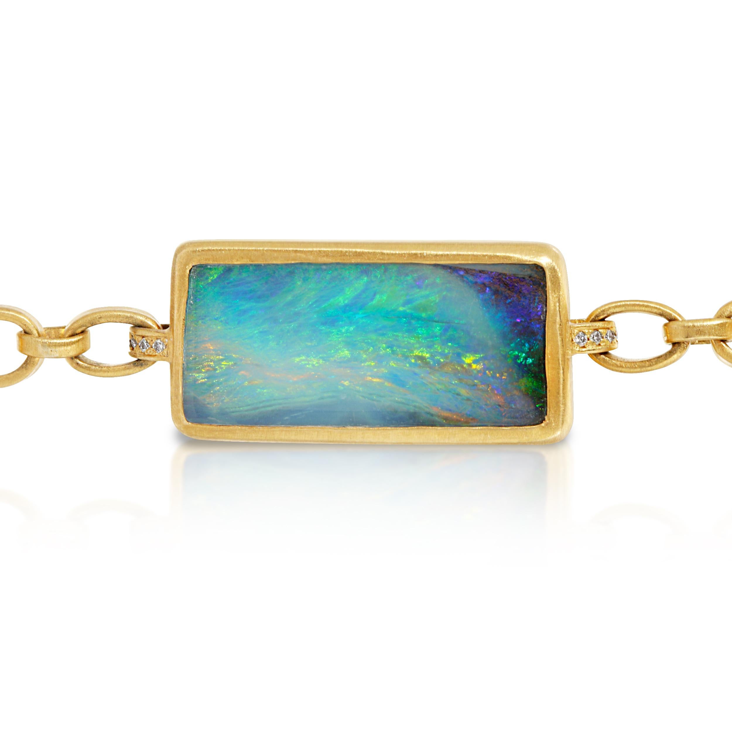 This 10.20ct Australian Opal Bracelet is Bezel set in 18k Matte Yellow Gold with a 19g Handmade Chain and Handmade Toggle Clasp with Diamond accents on the tips.  The Opal is attached to the Chain link Bracelet with Diamond accented loops.  This