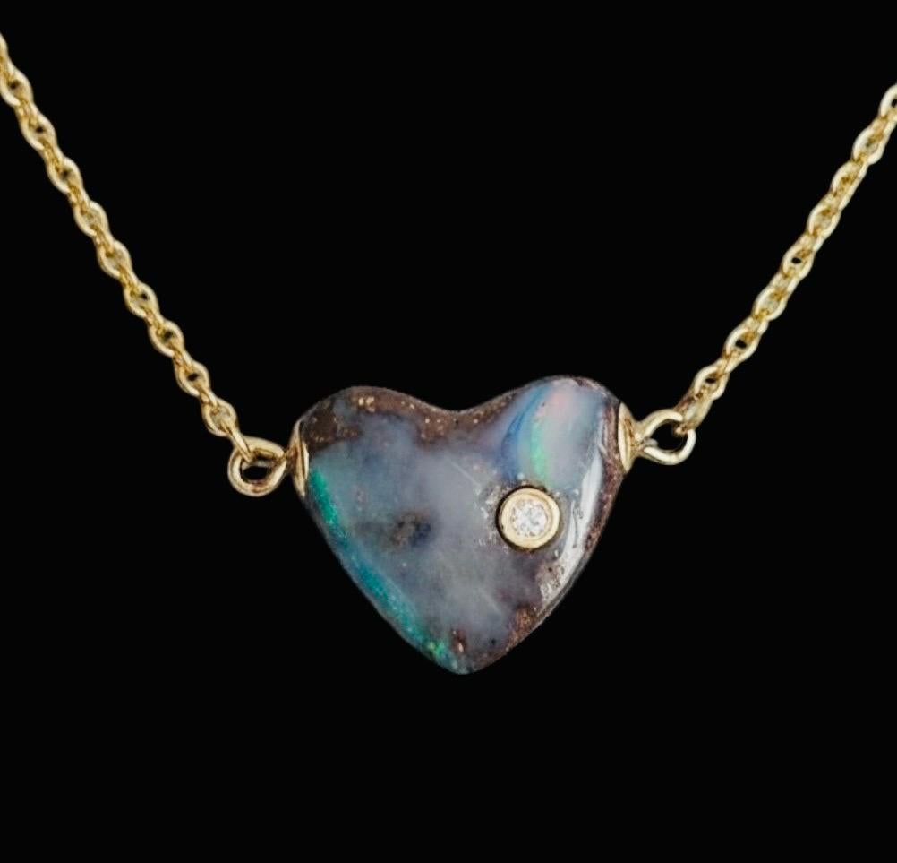 Opal Heart Necklace

Australian Opal, Diamond, 14k Gold

Australian Opal carved heart (1/2” in width) with one 2mm diamond bezeled in gold on a thin gold chain. 

Total length of necklace is 16” This makes it a great piece to wear on its own or add