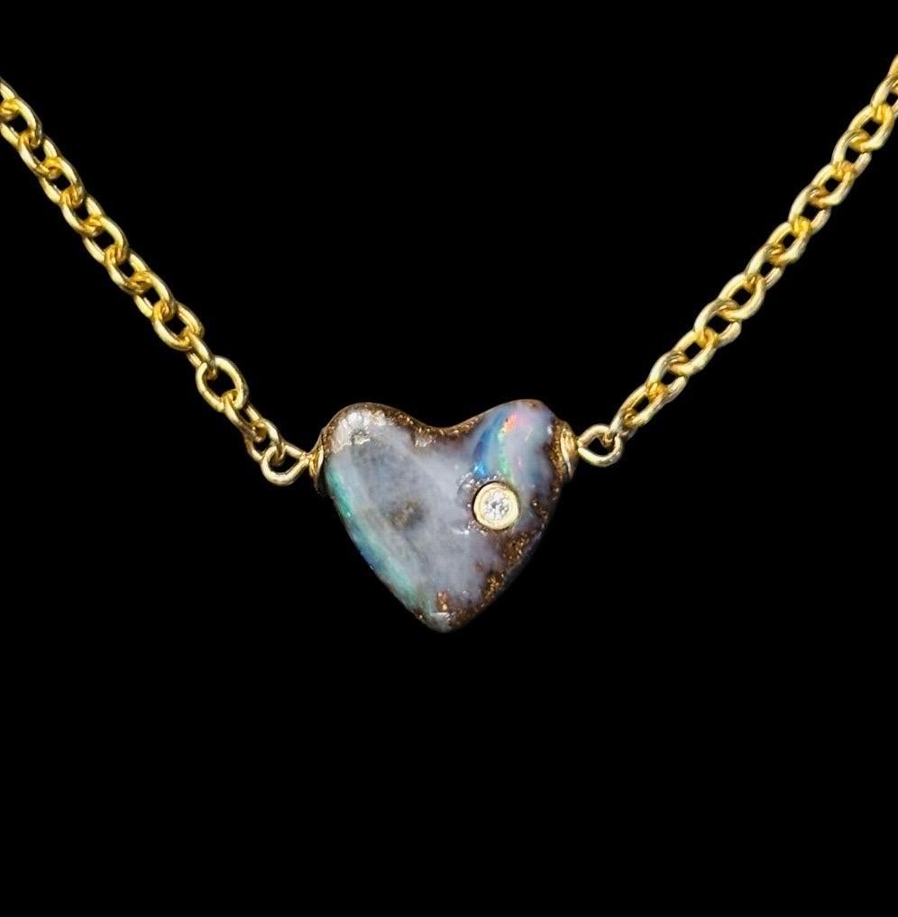 Australian Opal Heart Necklace

Australian Opal, Diamond, 14k Gold

Four carat Australian Opal carved heart (12mm width) with a 2mm gold bezeled diamond. 

The total length of this necklace is 16”, but a custom loop was added to the gold chain so