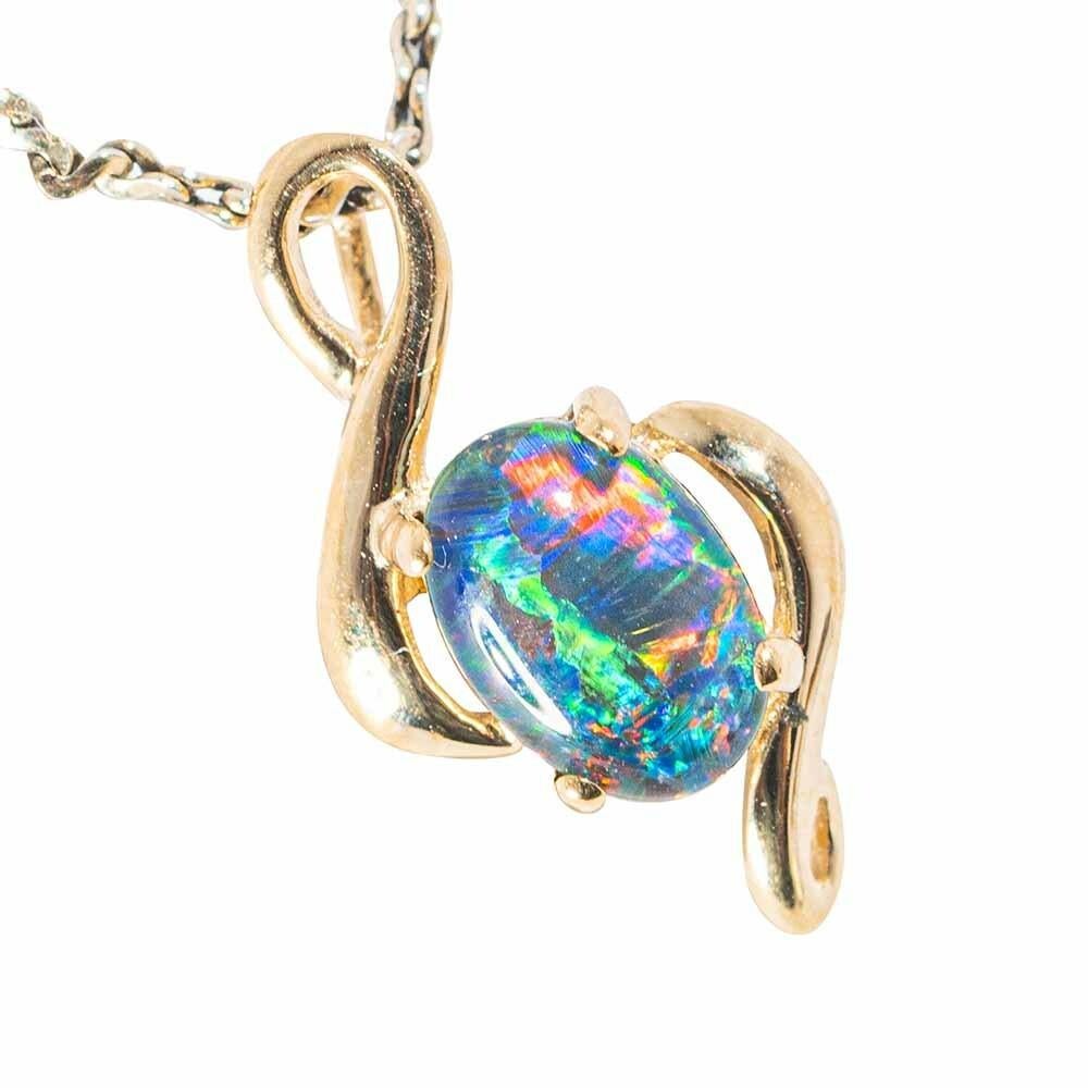 
Australian Opal Necklace 14 Karat Yellow Gold .  This Opal Shows off very bright colors Blue Yellow Green Orange Red and stands out. 

