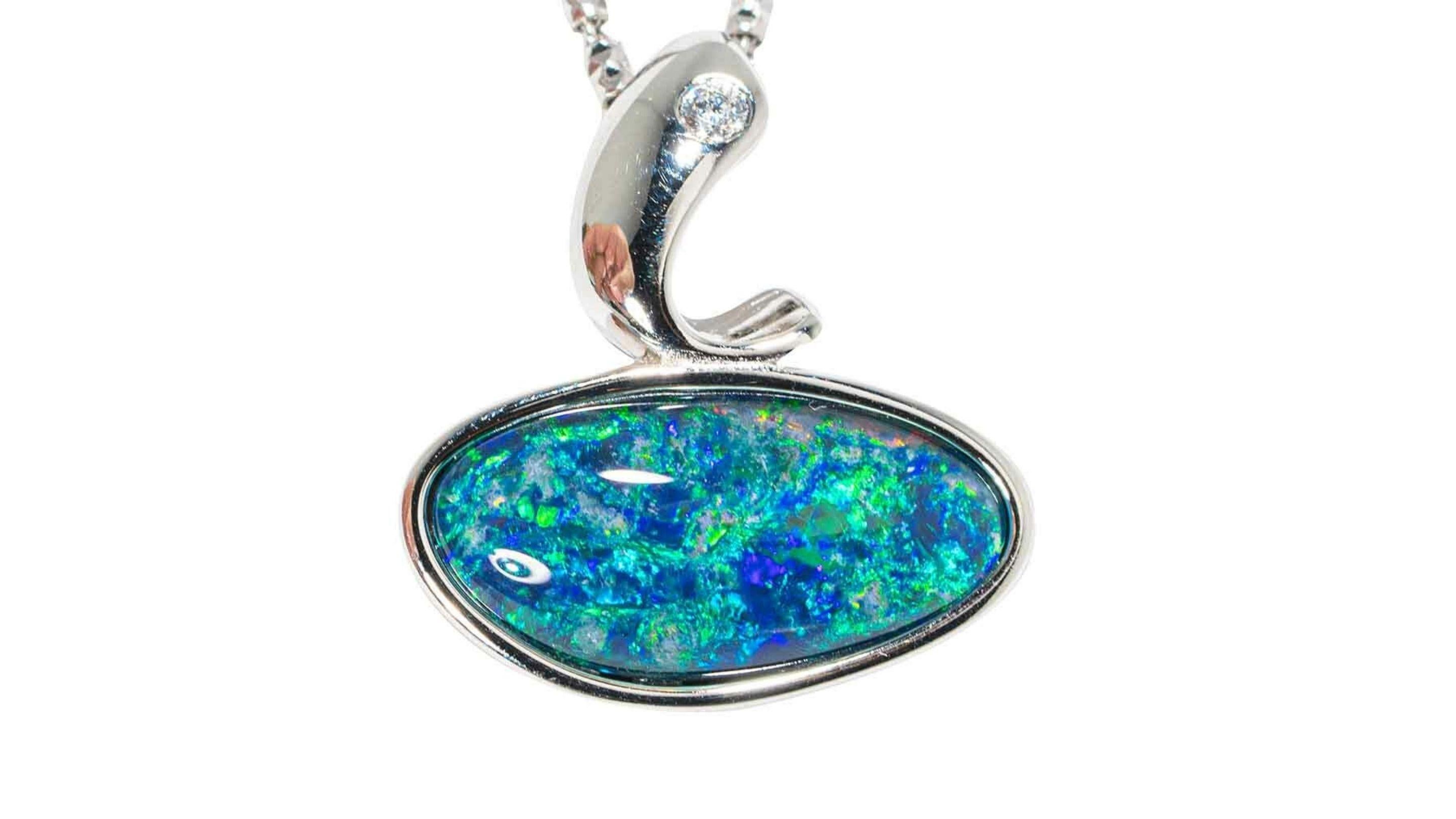 This Australian Opal Necklace in sterling silver shows off bright colors blues greens and really does stand out and has a accent stone sitting at the top.



GEMSTONE SETTING DIMENSION : 22X20MM
COLOR : MULTI COLOR
PATTERN : BROAD FLASH
BODY TONE :