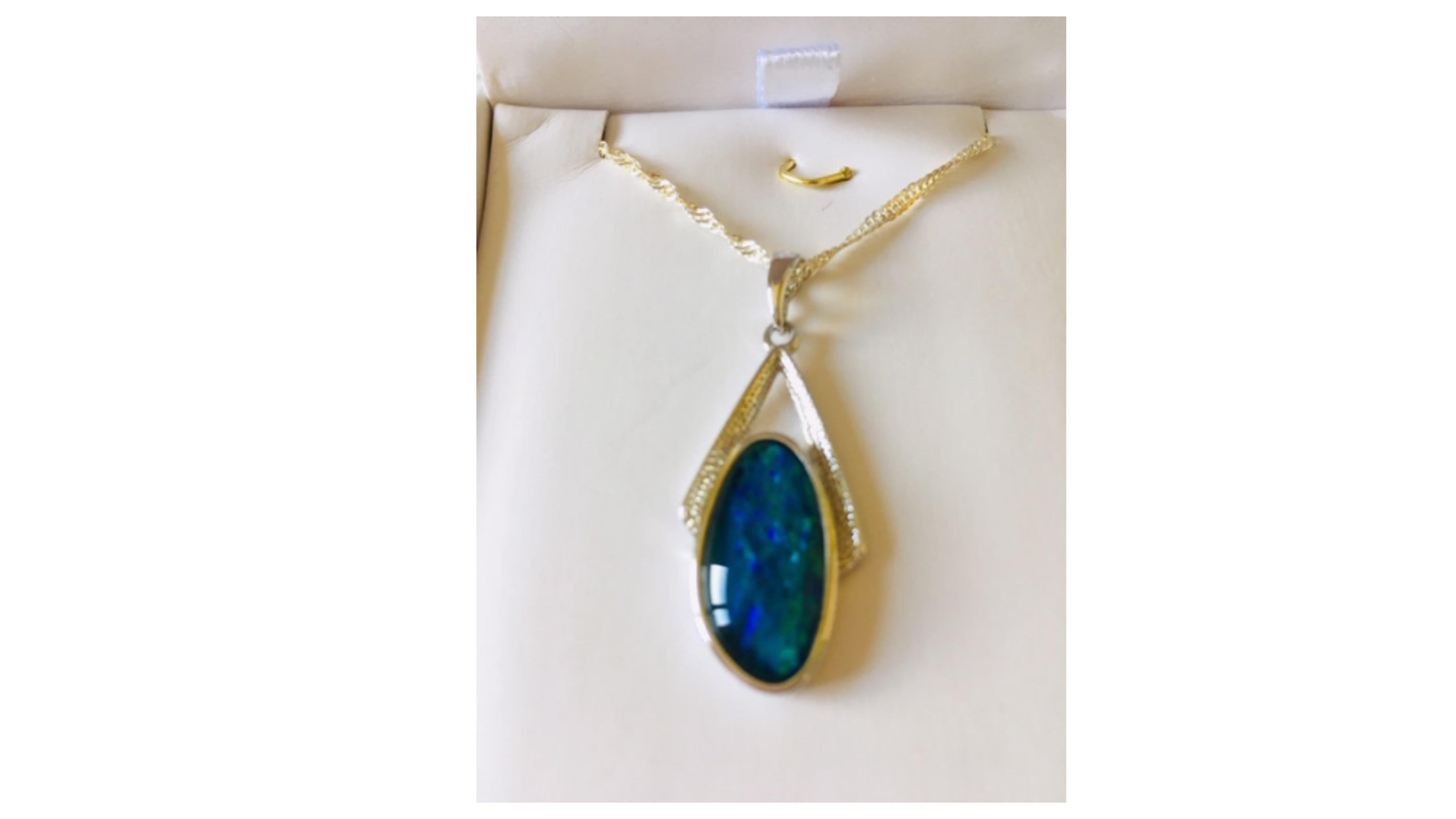 This is a unique Australian opal which shows off bright colors blue green and stands out  with the accent stones.   The vast majority comes from coober pedy in south Australia.  Its set in sterling silver and this is a one off item.

We have many