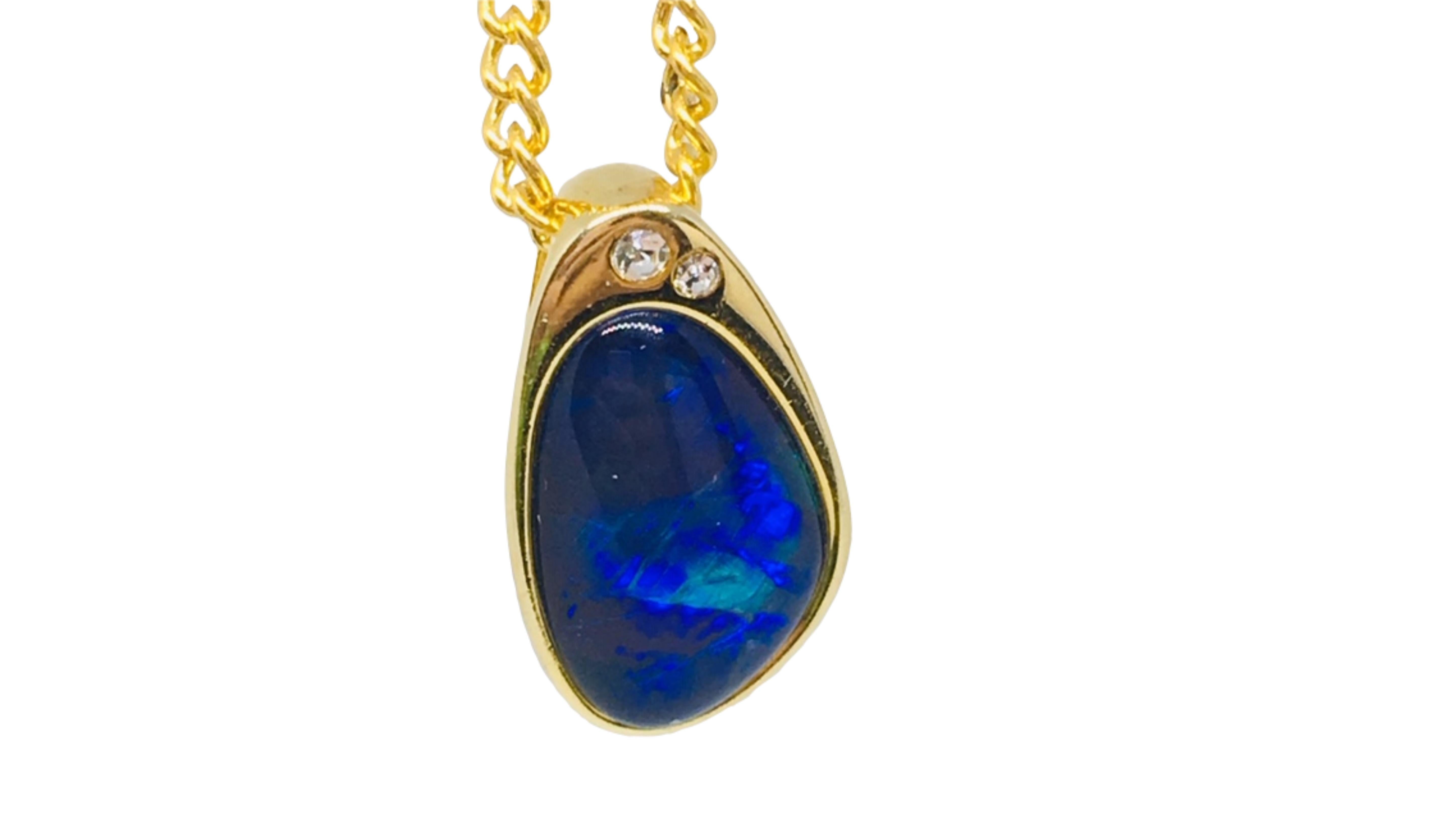 
Australian Opal Necklace Yellow Gold Plated  shows off this Bright Blue Color and you may see flashes of Green in too. It does stand out with the accent stones at the top too.  From Coober Pedy South Australia. 

