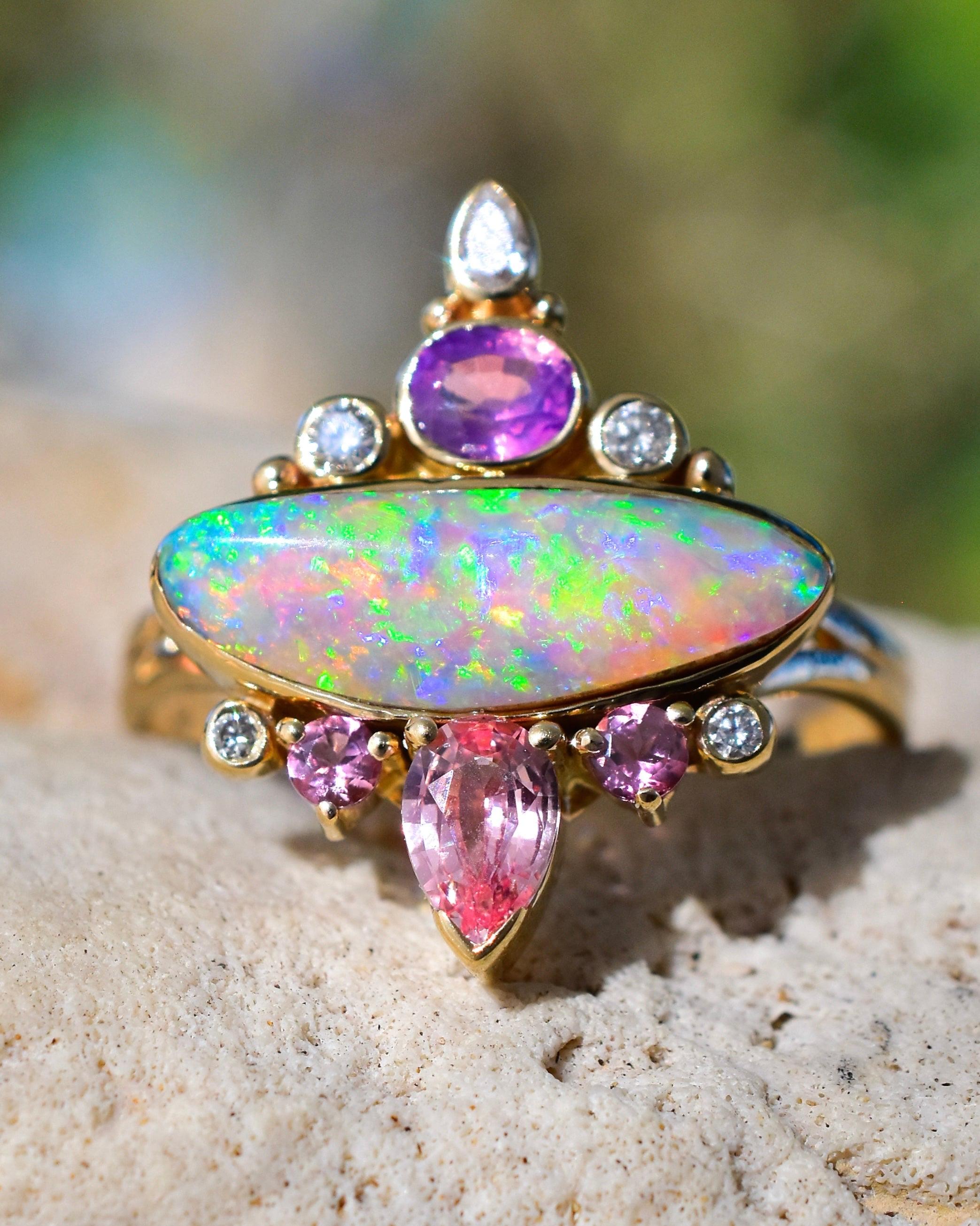 Fiery Australian Opal Pagoda Temple Ring with Opalescent Purple Sapphire, Lavender Peach Spinels and  Diamonds in solid 14k Gold. 22mm in length and 18mm wide. 

I’m absolutely stoked about this Australian opal ring—it’s an incredibly vibrant, fiery