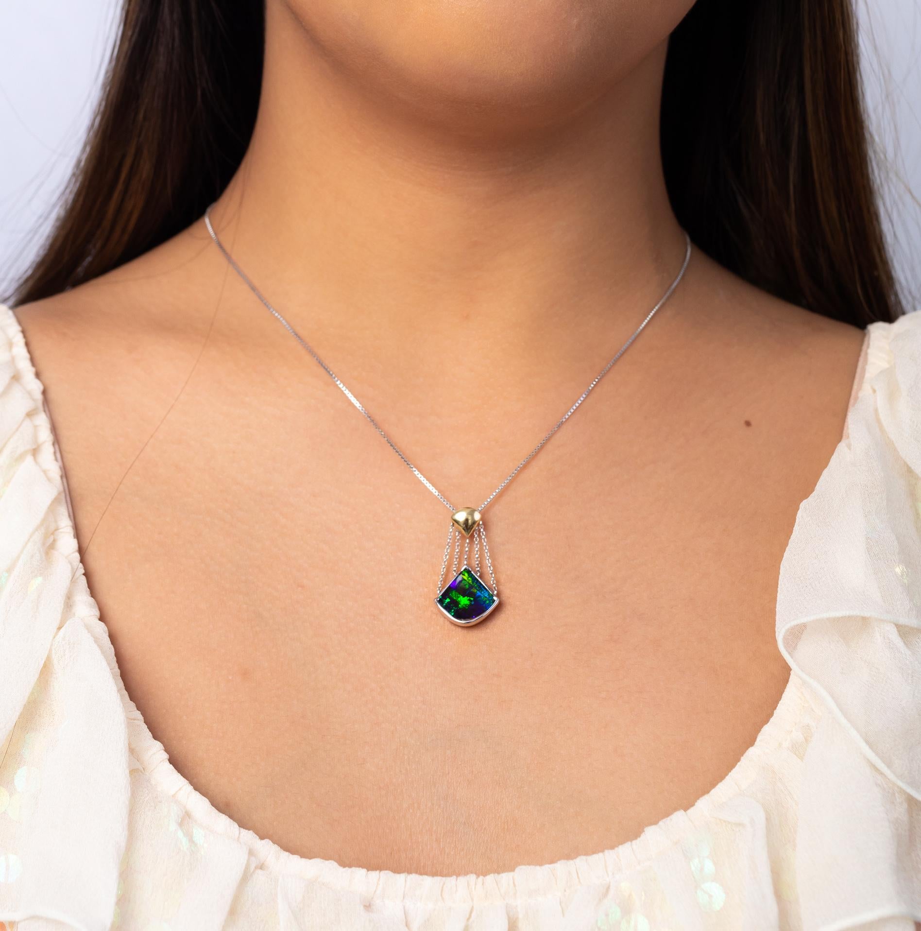 “Angel of the Waters” opal pendant captures the colours of distant oceans and far-off seas. An impeccable boulder opal (3.89ct) from Winton sways from droplets of 18K white gold that flow from a chalice of yellow gold. Perfectly dreamy when paired