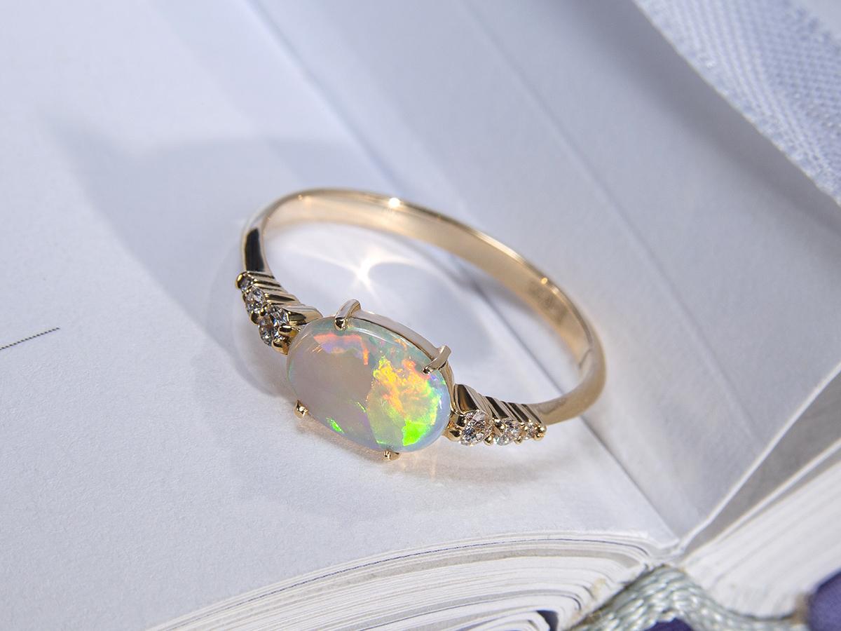 Australian opal 14K yellow gold ring with diamonds
opal origin - Australia 
opal measurements - 0.079 х 0.24 х 0.31 in / 2 х 6 х 8 mm
stone weight - 0.65 carats
ring weight - 1.59 grams
ring size - 6.5 US (this ring may be resized, please contact us