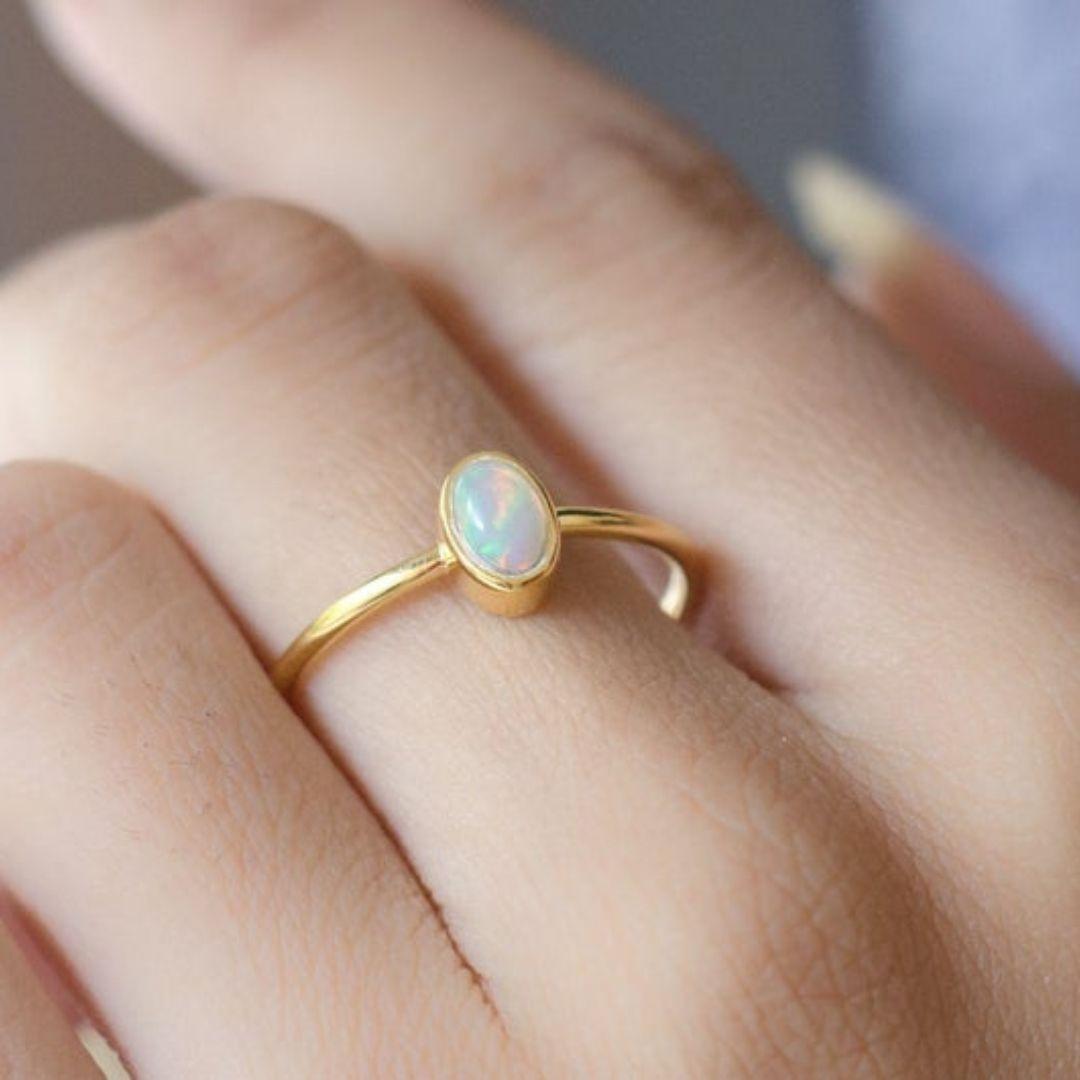Handmade item
Materials: Gold, Rose gold, White gold
Gemstone: Opal
Band Color: Gold
Style: Minimalist

Australian Opal Delicate Gold Ring. Rainbow opal dainty engagement ring with a thin gold band. Elegant stackable ring for everyday wear.
