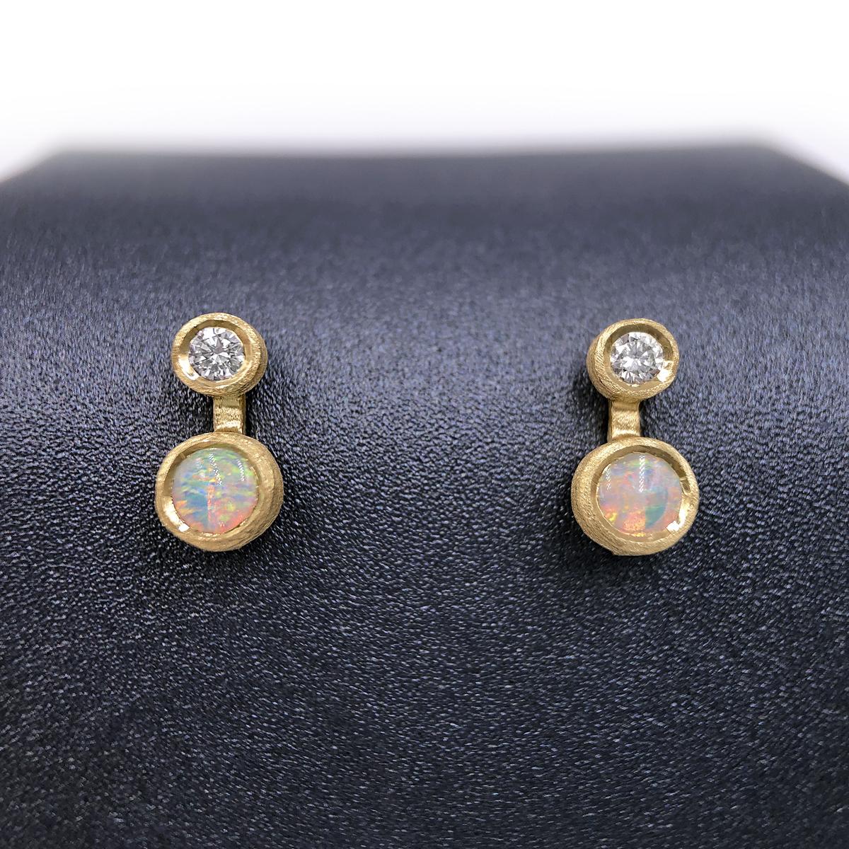 Nova Stud Earrings handcrafted in London by jewelry artist Shimell and Madden in satin-finished 18k yellow gold with 0.08 total carats of round brilliant-cut white diamonds and a matched pair of Australian opal cabochons, all bezel-set and attached