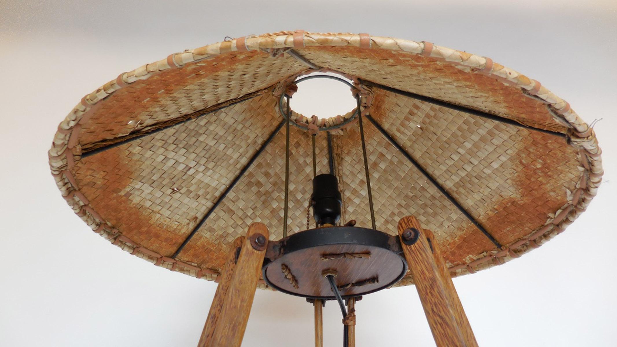 This lamp made in Fiji, in the 1990s is constructed of palm wood and leather and rope. In very good condition. Beautiful variegated colors throughout sustainable tropical palm wood. Great patina! Interesting construction and all views are fantastic.