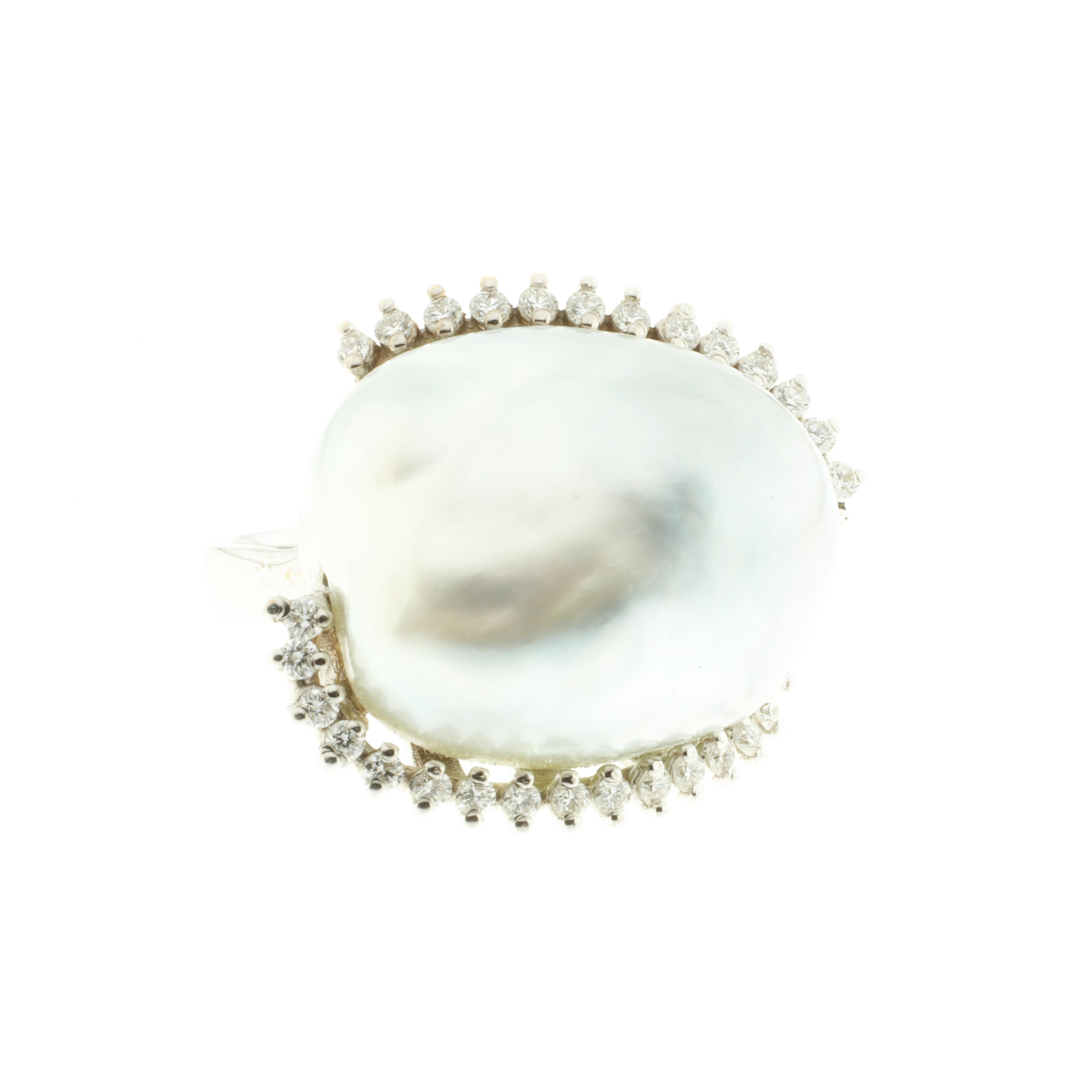 A stunning cocktail ring that is glamorous both on and off the hand: it is daring and unusual in its design. Created from 18-karat white gold, this ring features a massive 29.4-carat Australian pearl, bordered by a single row of white diamonds, all