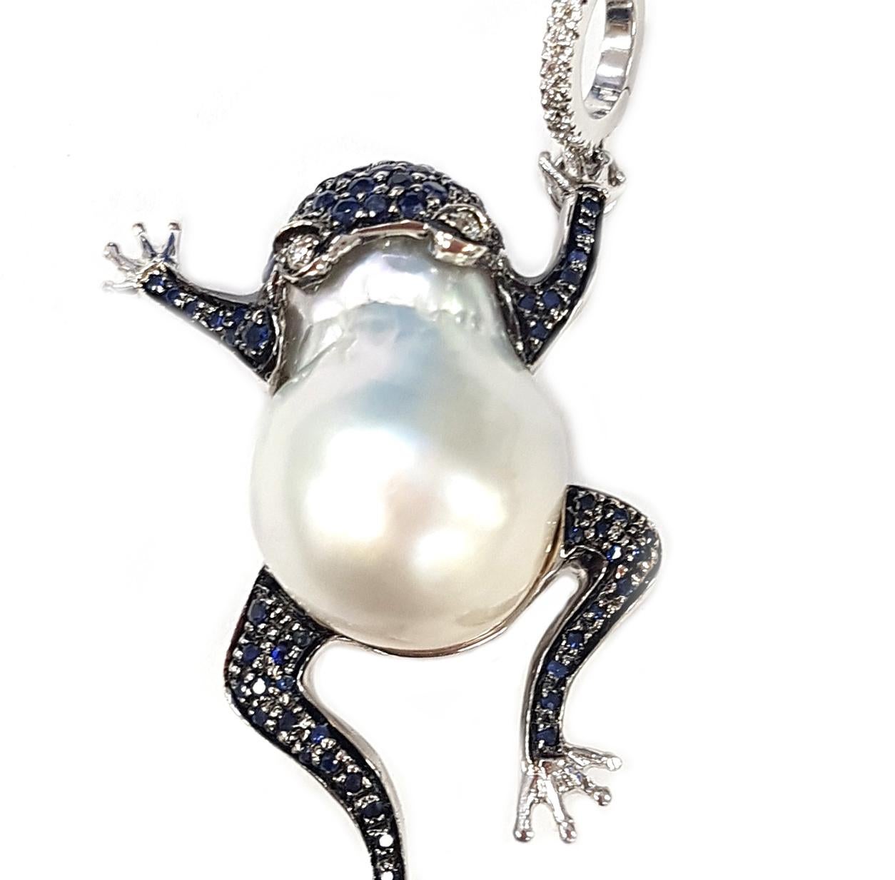 This lovely pendant is made of a large white Australian pearl which has been made into a leaping frog's body. The head and legs of the frog are set with gorgeous, midnight-blue sapphires while white diamonds create the lovely bright eyes of the
