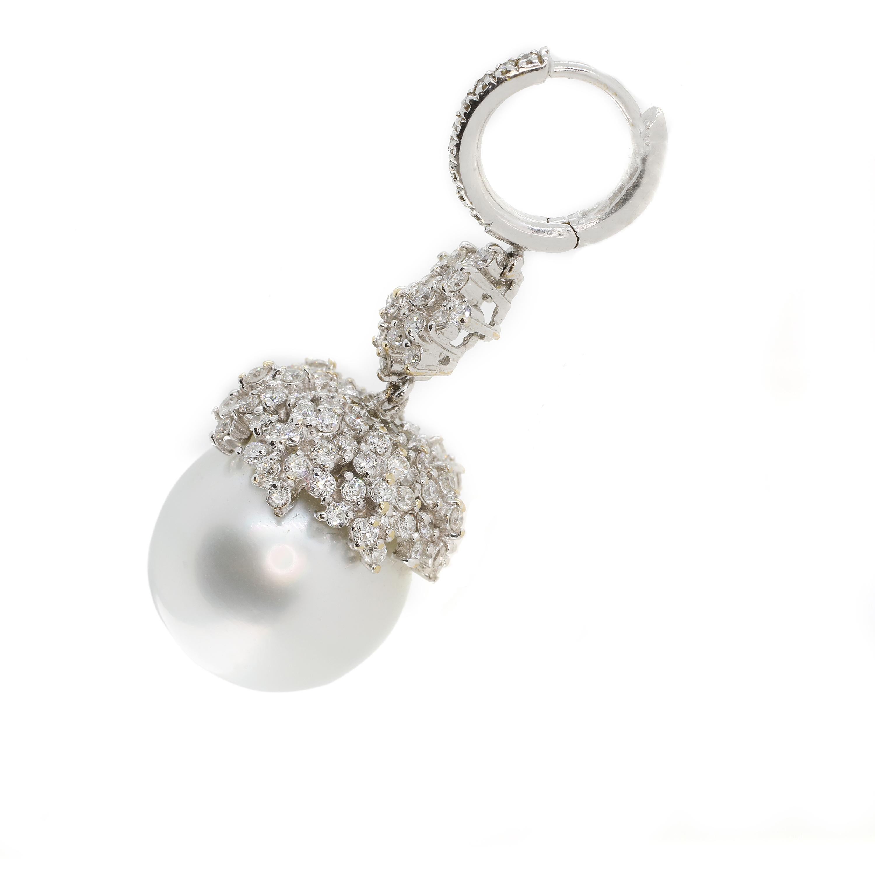 These earrings are sublimely designed around two large Australian pearls that weigh 61.80 carats (combined) and set with 2.46 carats of white diamonds in 18-karat white gold. The earrings are 40 millimetres long and feature a gorgeous circle clasp