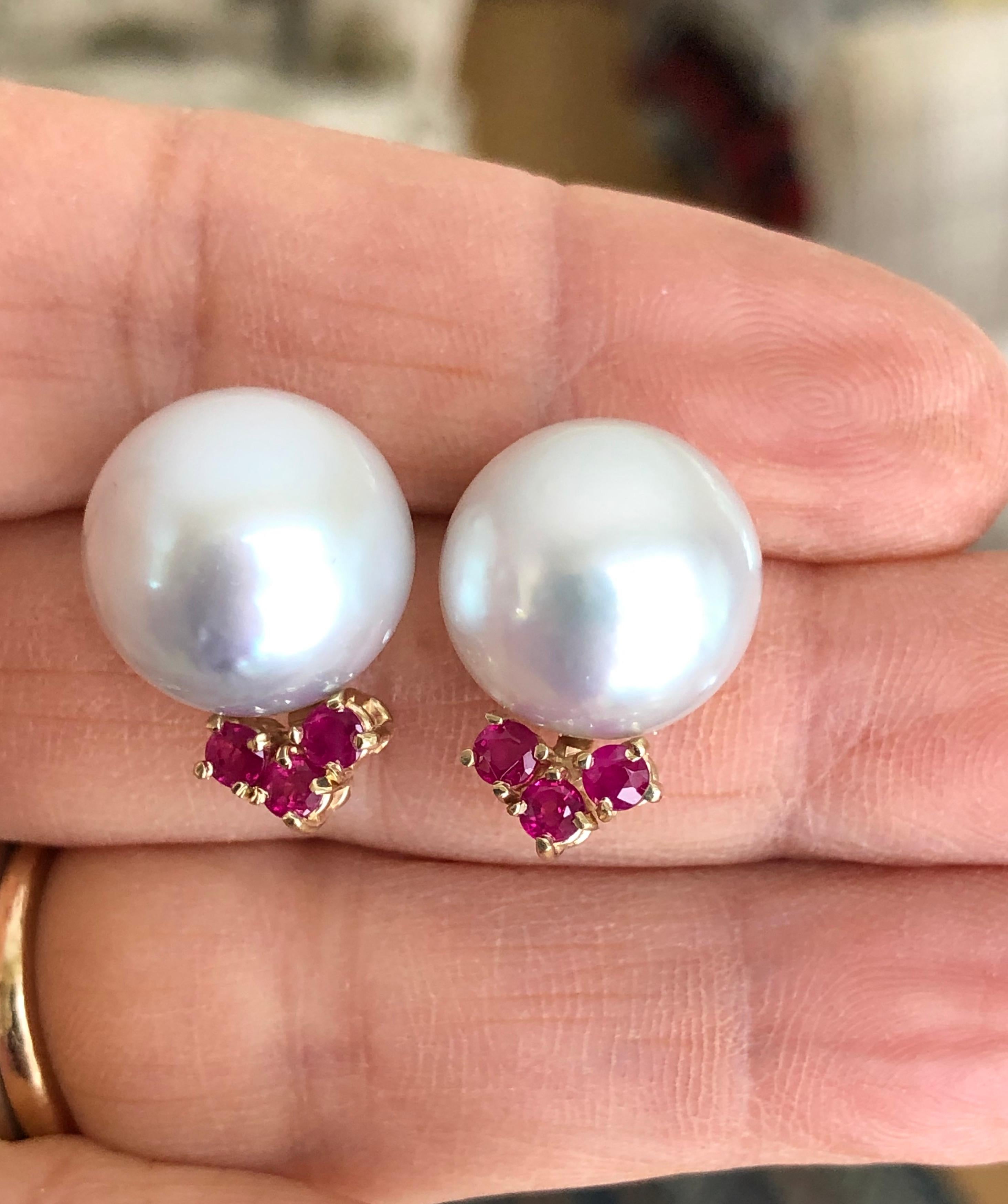 A pair of Australian pearls are set into a beautiful design of 14 karat yellow gold set with 0.90 carats of natural ruby. These gorgeous earrings allowing the wearer at every occasion. 
pearl shape: round
type: South Sea Cultured Pearls Pearl
pearl