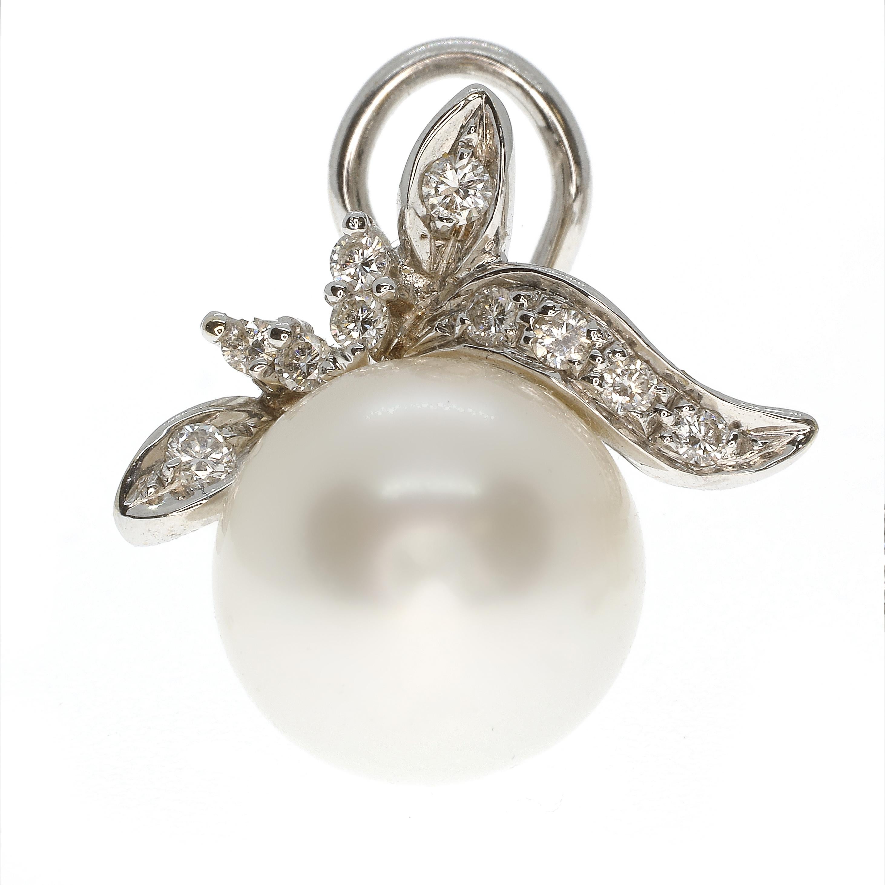A pair of Australian pearls weighing 27.82 carats and 12.5mm across are set into a delicate design of 18-karat white gold set with 0.50 carats of white diamonds, rated G VS. These gorgeous earrings are spectacular, picking up any light in the room,