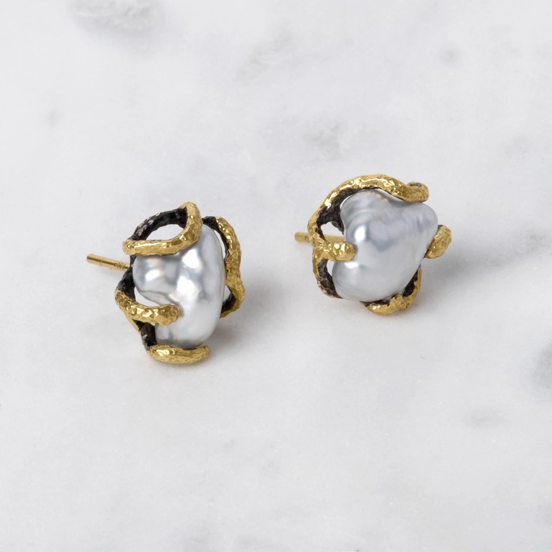 This one of a kind pair of earrings are from Lingjun's 'FISSURE' collection, featuring white Australian South Sea Keshi pearls. 

The unique organic lines of gold were custom carved to match the pearls' natural shapes, allowing their audience to