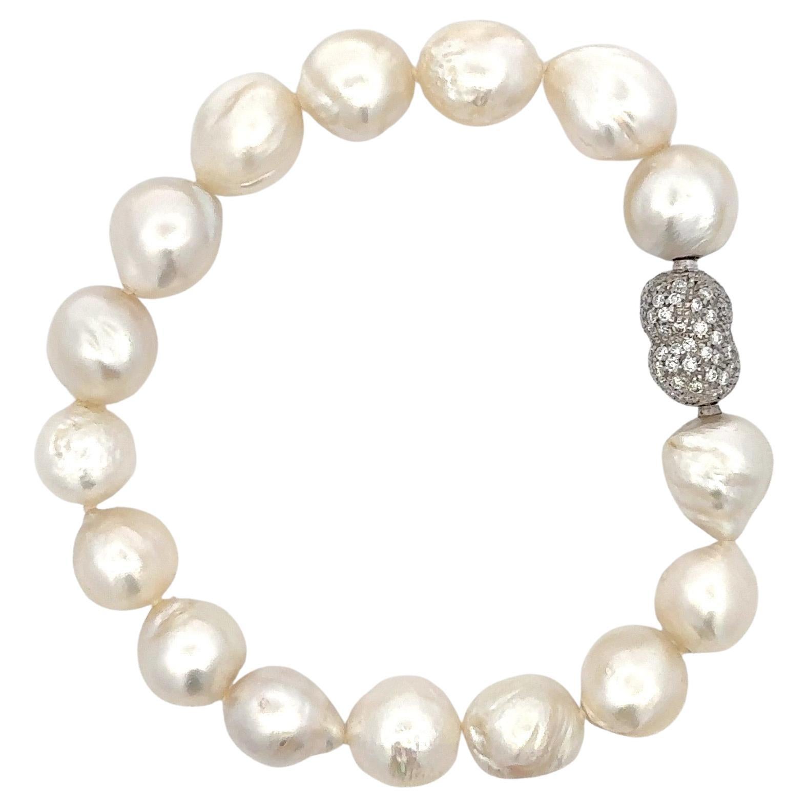 A strand of sixteen Australian South Sea Pearls measuring mm and a diamond nugget clasp containing round brilliants weighing 1.50 carats in Platinum. 
Pearls measuring 13-15 MM