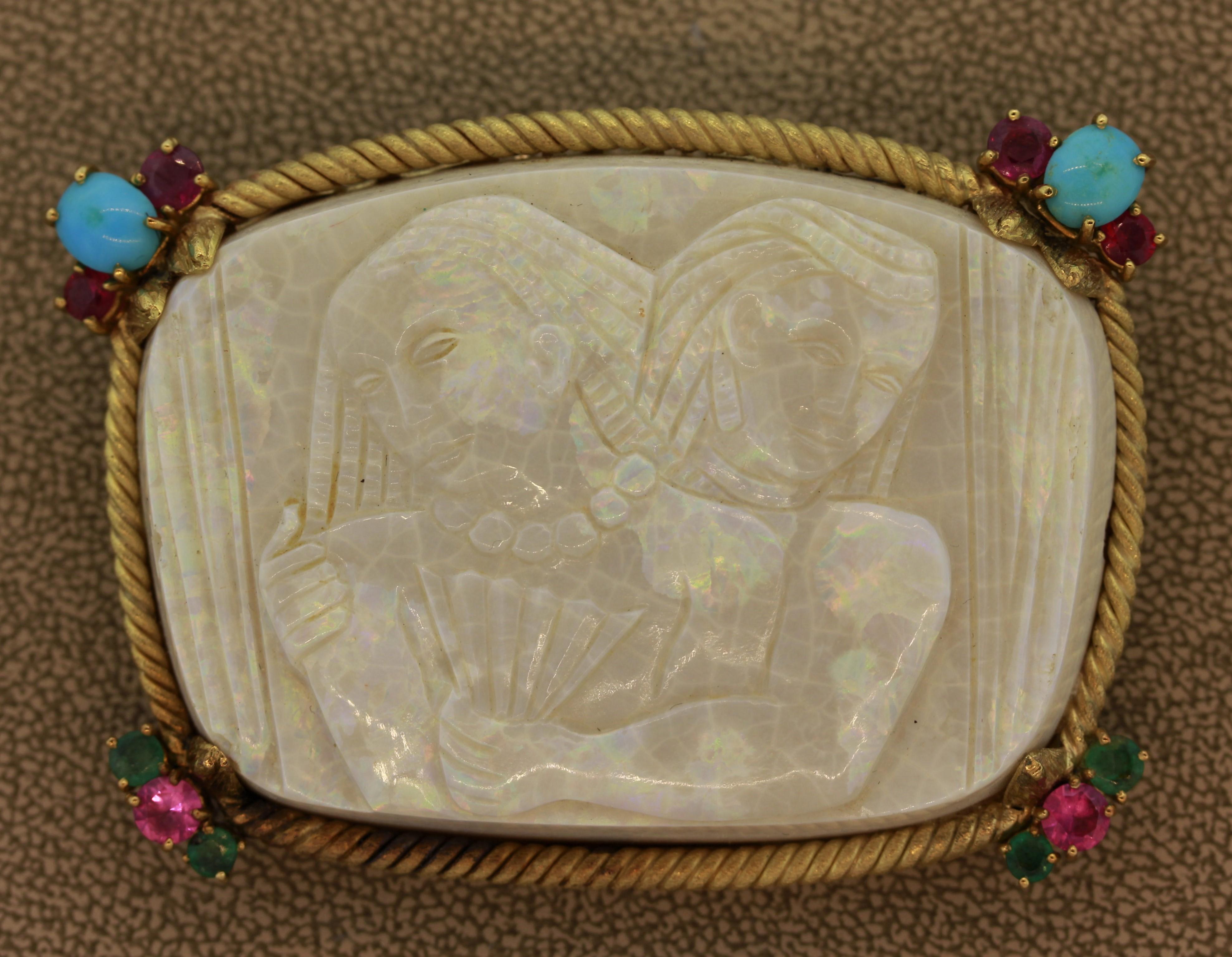 A special piece of art made of a natural piece of Australian white opal. It is hand carved depicting an Ancient Egyptian couple with strong detail and realism. The opal has great play of color as flashes of green, red and everything in between can