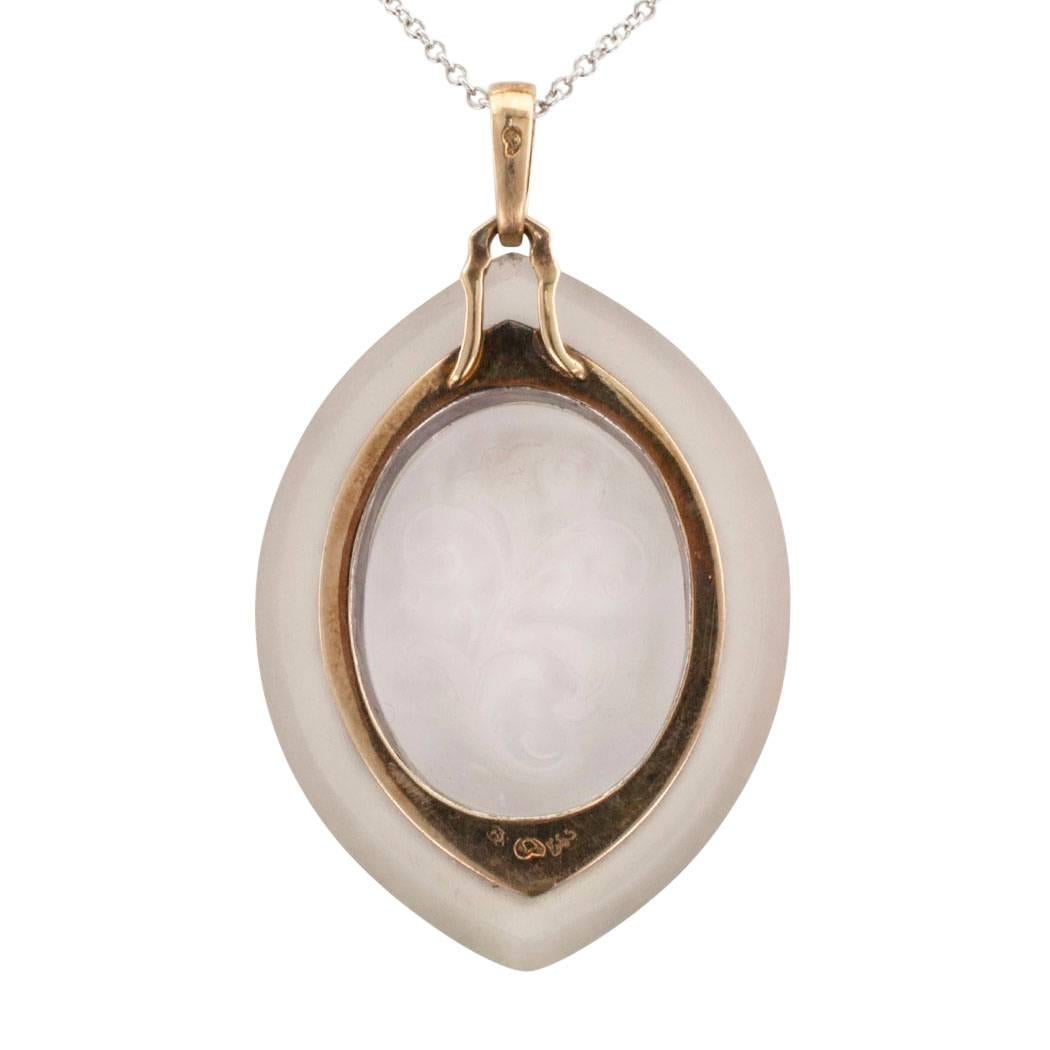 Austrian 1900s rock crystal diamond and onyx pendant mounted in silver and gold. Crafted in silver and 14-karat gold, the antique, navette-shaped design features a central plaque fashioned from clear rock crystal carved with a morning glory vine