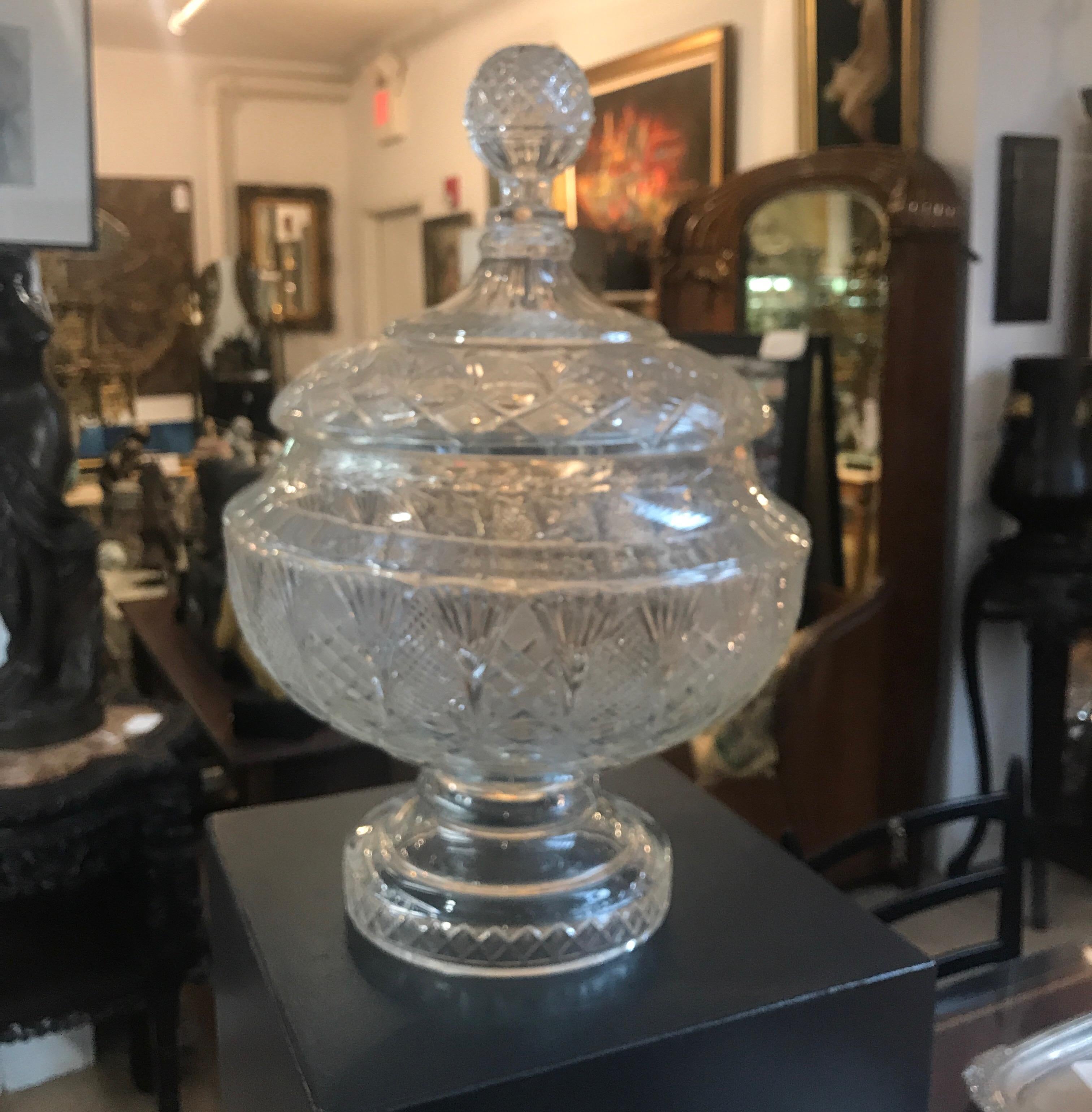 Extraordinary large cut glass punch bowl centerpiece on pedestal base with lid. The lid with diamond cut ball finial rests on a shapely detailed cut glass bowl with round pedestal base, Austrian, circa 1870.