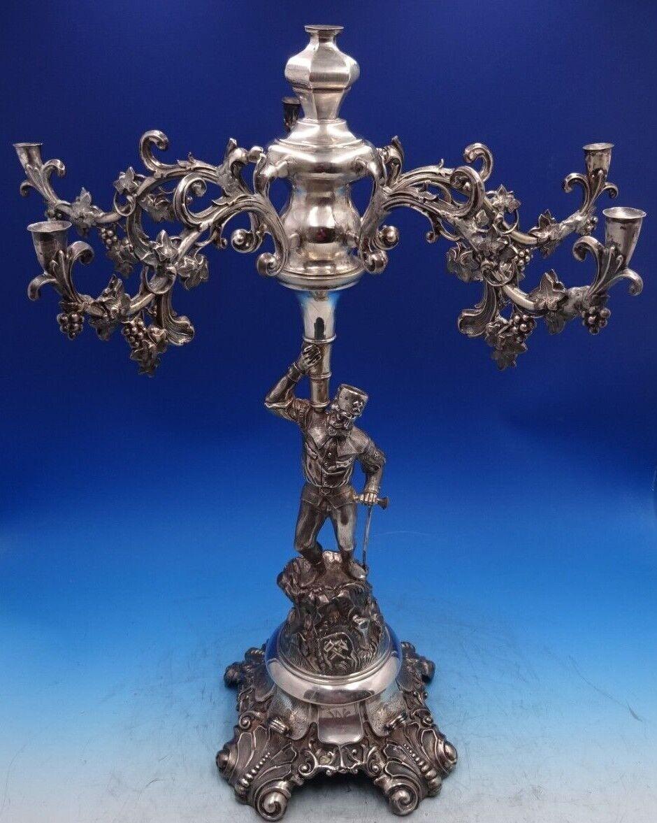 Austrian .800 Silver

Incredible Austrian .800 silver 6-light candelabra / epergne from Vienna, Austria (maker unknown). This massive piece features a three dimensional man holding an axe on a rocky base with lizard and foliage. This piece does