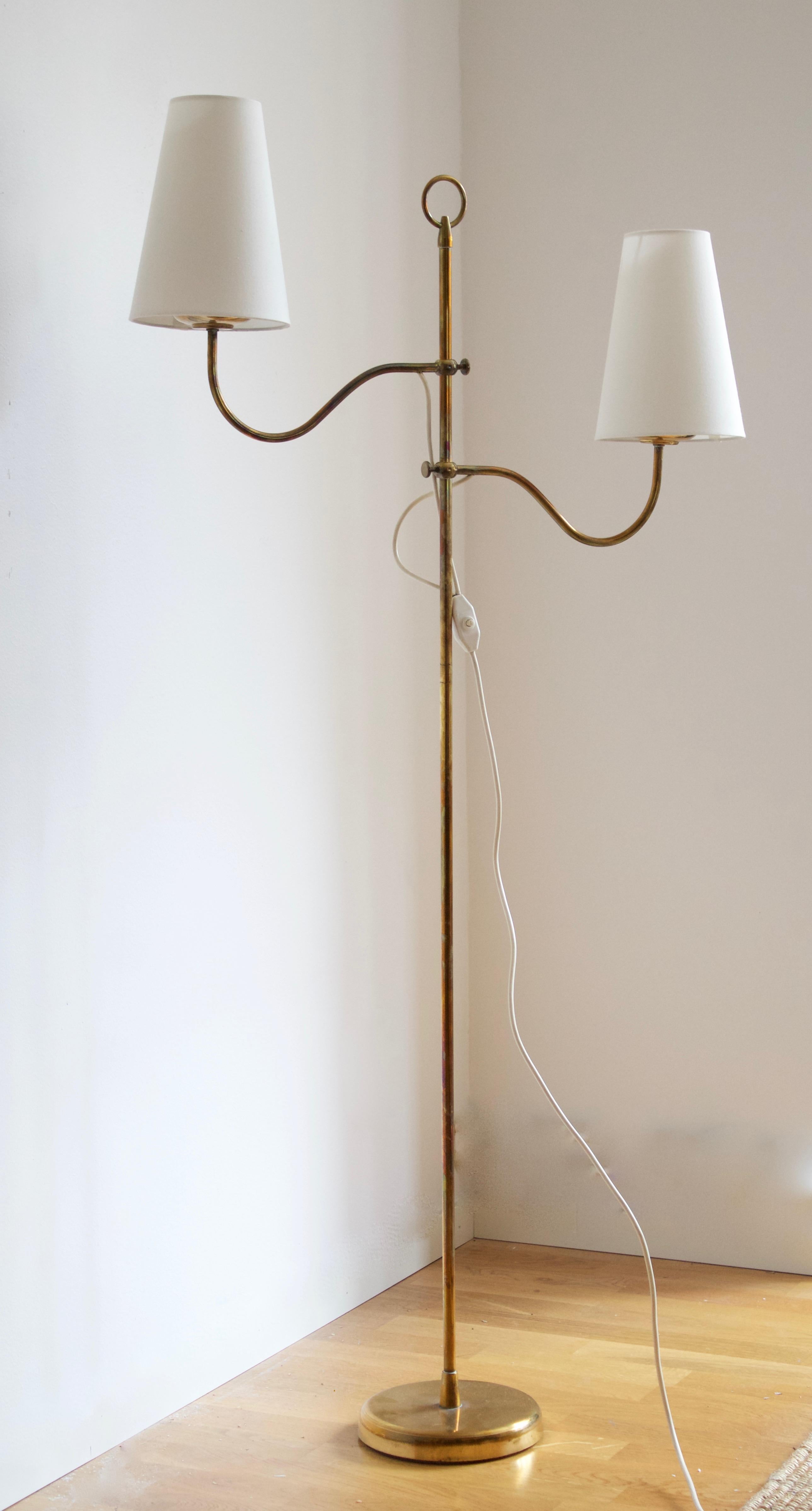 An adjustable functionalist floor lamp. Designed and produced in Austria, c. 1950s. In brass. Brand new lampshades.

Dimensions stated measured with lampshades attached.