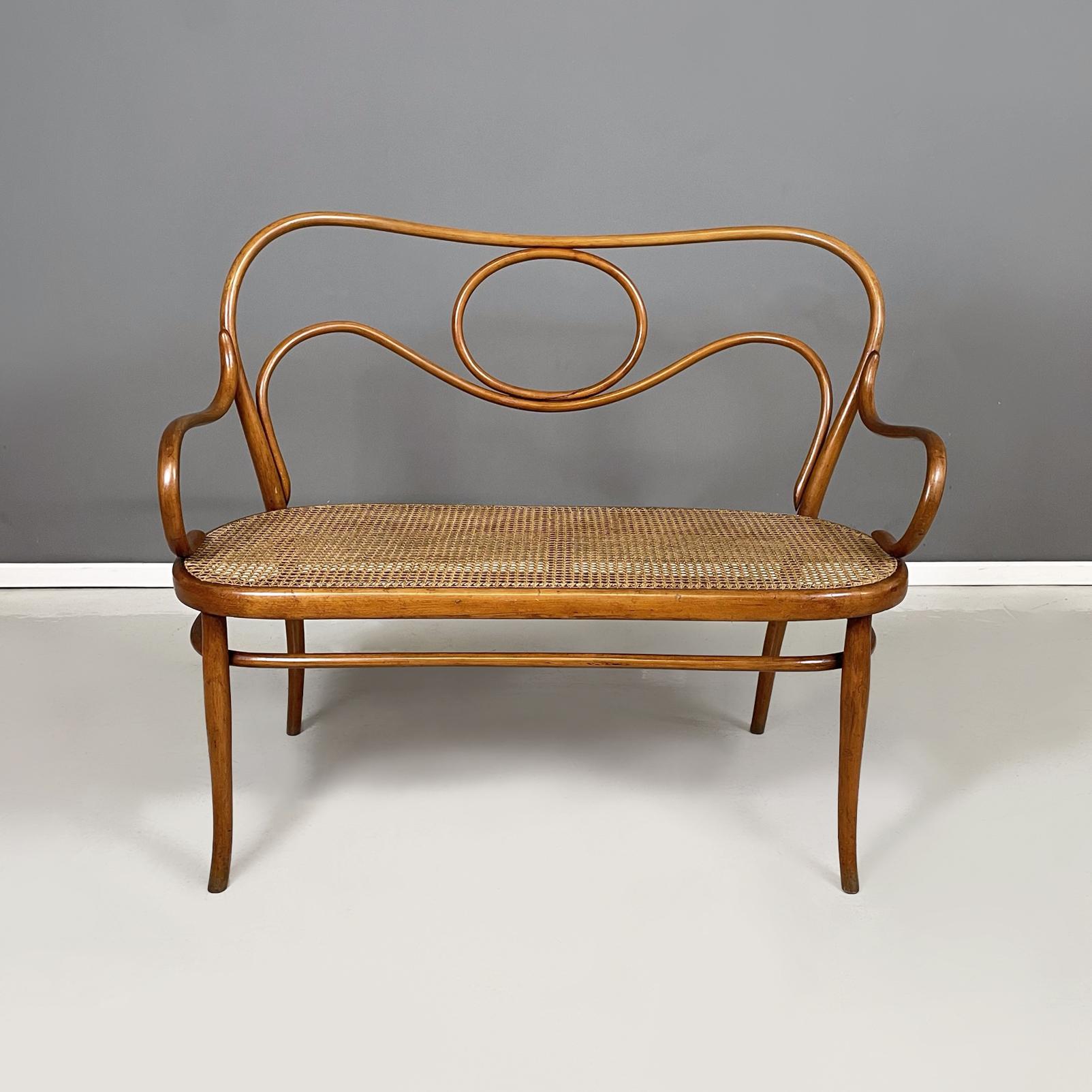 Austrian antique Wooden and Vienna straw two-seater bench by Thonet, early 1900s
Two-seater bench with handmade Vienna straw seat. The backrest, the armrests and the legs are in curved wood with a round section.
Produced by Thonet at the beginning