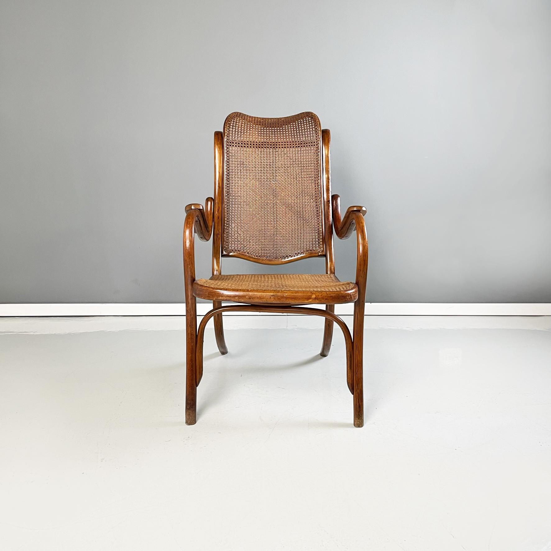 Austrian Armchair with dark brown straw and solid wood in Thonet style, 1900s
Armchair in Thonet style with structure in finely worked dark solid wood . The inclined backrest and the seat are in dark brown Vienna straw. Curved armrests