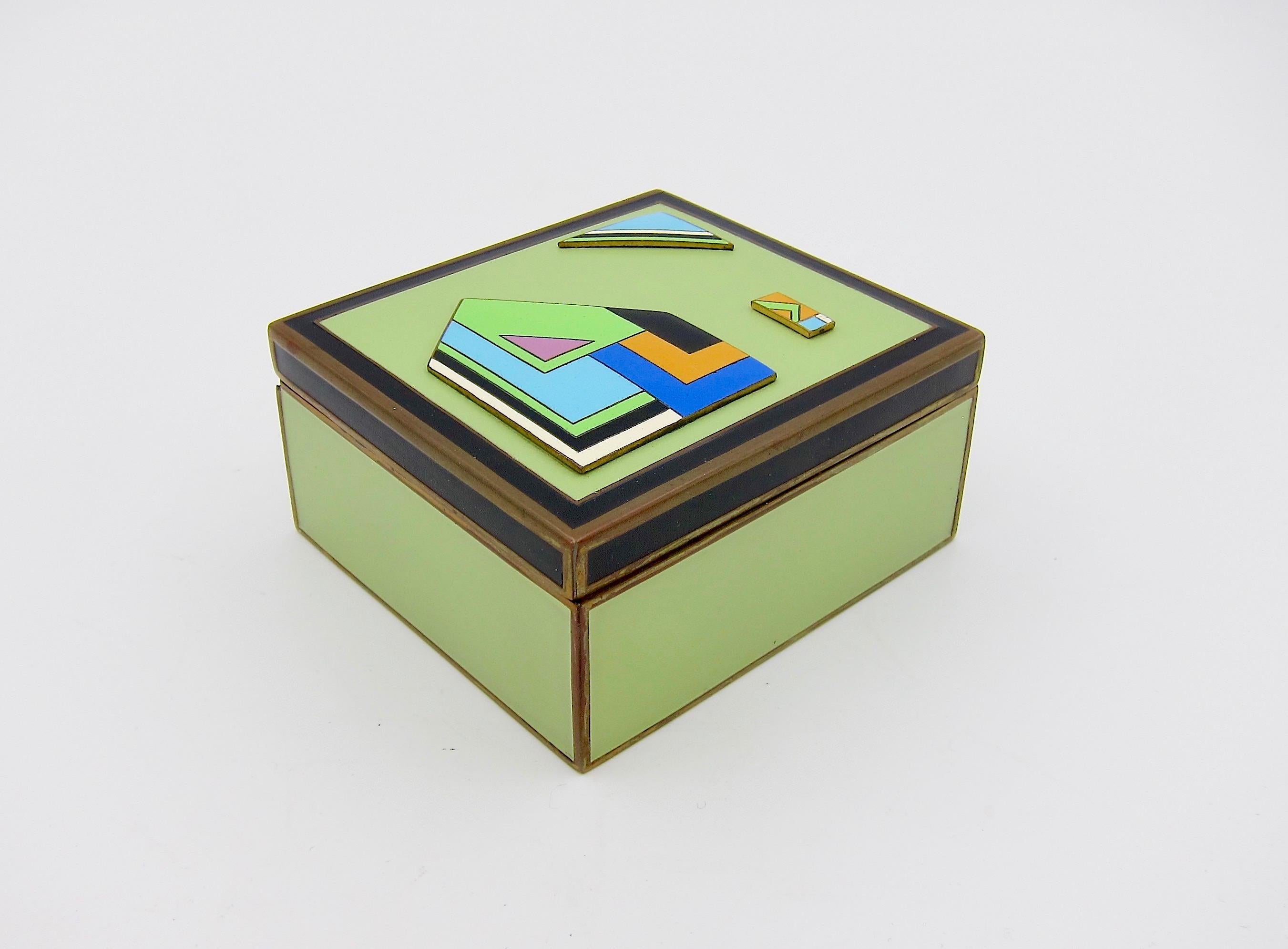 A hinged Art Deco period box in metal, wood, and enamel, made in Austria, circa 1930. The wooden lining indicates it was likely a humidor or cigarette box; today, it would make an ideal desk accessory or an attractive keepsake or jewelry box atop a