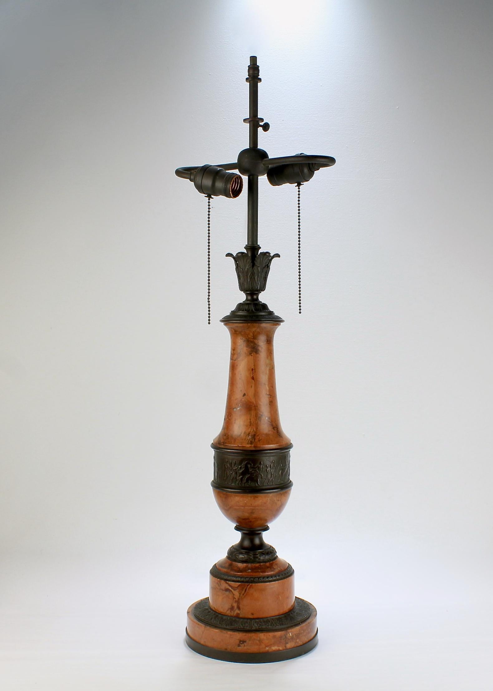 An Art Deco period Austrian bronze and marble lamp.

Retailed by Benjamin Altman and Co., the longtime luxury Midtown Manhattan retailer.

Comprised of alternating chocolate colored bronze and marble elements.

The marble has pink, yellow and